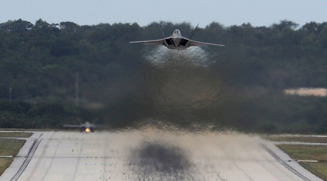 An F-22 Raptor takes off at Andersen Air Force Base, Guam while another waits for clearance March 5. The Raptors are deployed from Elmendorf Air Force Base, Alaska to the 90th Expeditionary Fighter Squadron at Andersen. The base received 14 of the $140 million dollar aircraft, and more than 250 Airmen for a three month deployment as the Pacific's Theater Security Package. The stealth-fighters, along with associated maintenance and support personnel will participate in various exercises that provide routine training in an environment different from their home station. 
 

(U.S. Air Force photo/ Master Sgt. Kevin J. Gruenwald) released






















  












 











































  












 


























