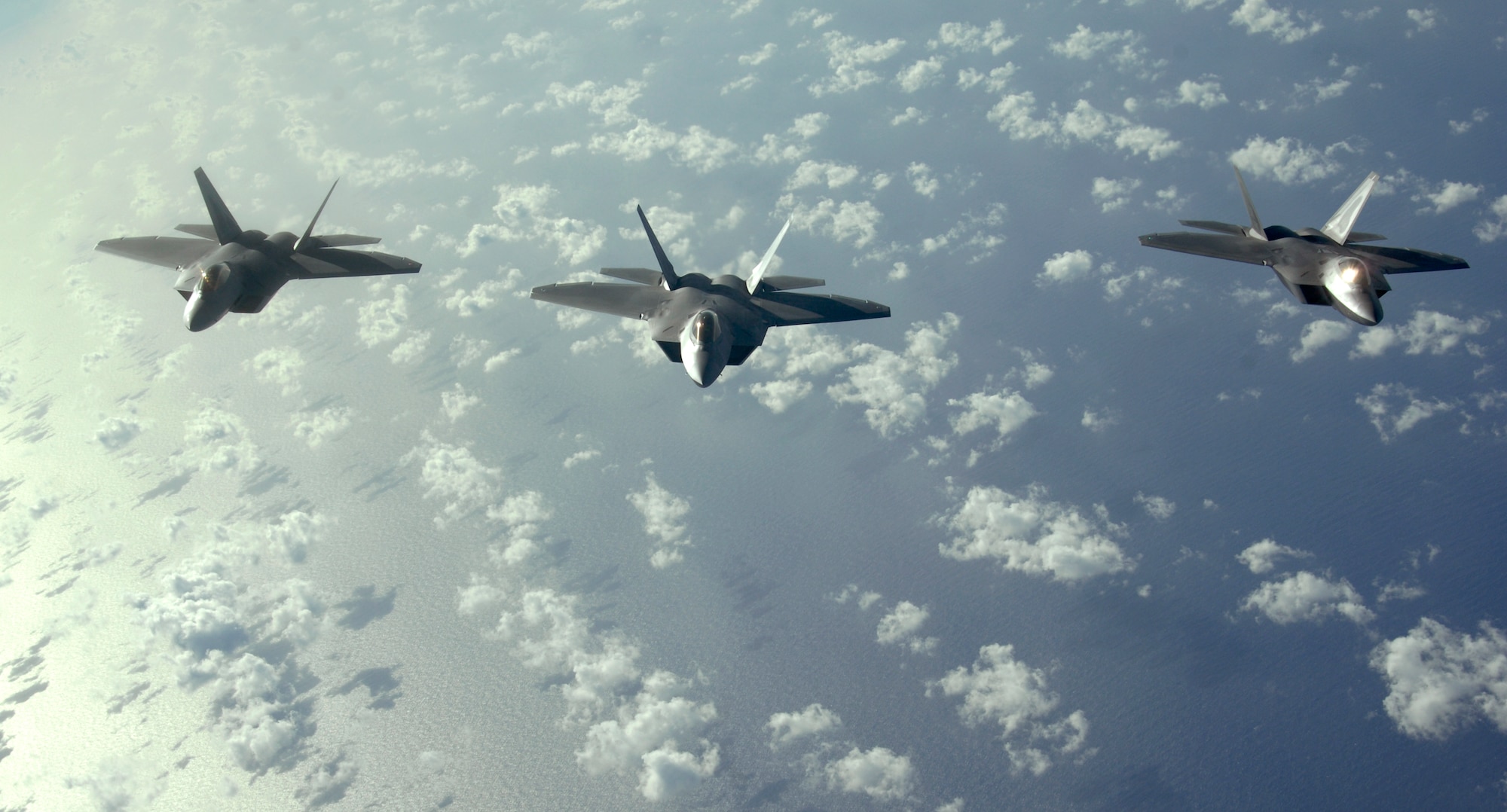 A three-ship of F-22 Raptors fly over the Pacific Ocean during a recent Pacific theater mission.  The Raptors are deployed from Elmendorf Air Force Base, Alaska to the 90th Expeditionary Fighter Squadron Andersen Air Force Base, Guam. Andersen received 12 of the $140 million dollar aircraft, and more than 250 Airmen for a three month deployment as the Pacific's Theater Security Package. The stealth-fighters, along with associated maintenance and support personnel will participate in various exercises that provide routine training in an environment different from their home station. 

(U.S. Air Force photo/ Master Sgt. Kevin J. Gruenwald) released






















  












 











































  












 

























