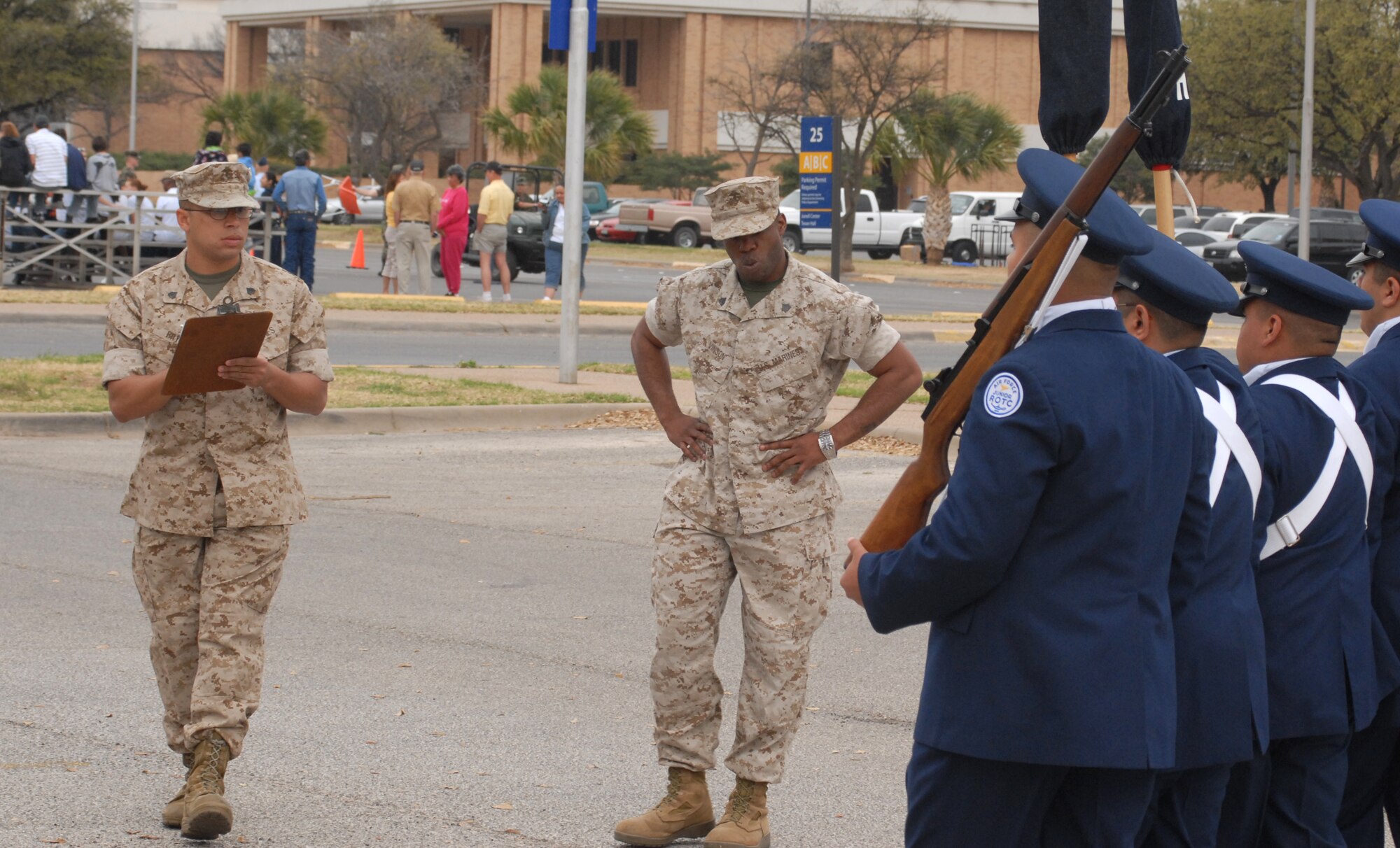 Air Force Junior Reserve Officer Training Corps color guard team from Lakeview High School, San Angelo, Texas get inspected by Sgt. Clifford Vinson and Sgt. Shaywon Bryant, Marines from Goodfellow Air Force Base.  Angelo State University held its annual Texas high school JROTC drill competition on March 7.  The event was hosted by the ASU Air Force ROTC Det 847.  About 125 junior JROTC students from 11 West Texas high schools, making up over 60 teams competed in armed and unarmed regulation, exhibition and inspection drills, individual drills, tandem drills, color guard and physical fitness event called the Warrior Challenge.  Judges included ASU AFROTC cadets and Army, Marine Corps and Navy personnel from Goodfellow Air Force Base. (U.S. Air Force photo by Senior Master Sgt. Robert Martinez)