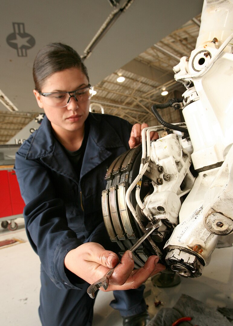 Airman 1st Class Nicole Furwa, 149th Maintenance Squadron, installs landing gear brakes on an F-16 Fighting Falcon March 10. The 149th MXS is part of the 149th Fighter Wing, an F-16 training unit located on Lackland. (USAF photo by Robbin Cresswell)