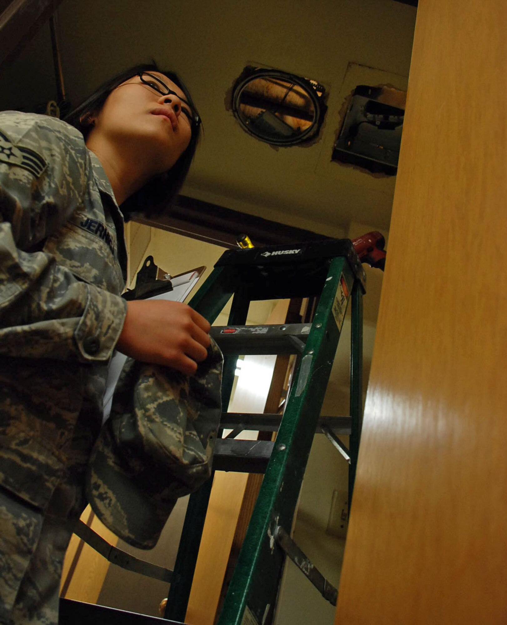 LAUGHLIN AIR FORCE BASE, Texas – Senior Airman Allison Jernigan, 47th Installation Support Squadron engineer assistant, inspects the bathroom ceiling March 12 of one of the three enlisted dormitory rooms that are being renovated by contractors here. “I really enjoy my job here at Laughlin,” said Airman Jernigan. “It’s been a great learning experience for me because I’ve been introduced to so many new things and I really enjoy helping out my fellow Airman.”  (U.S. Air Force photo by Airman 1st Class Sara Csurilla) 