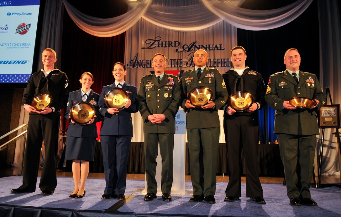 U.S. Air Force Staff Sgt. Stephanie Cates, Medical Technician, Urology Clinic, 779th Medical Group, (second from right) along with representatives from every branch service accept the Angels of the Battlefield Awards during a gala dinner in honor of military medics and corpsman at the Ronald Reagan Building in Washington, D.C., March 11, 2009.  Cates was nominated to receive the award on behalf of all U.S. Air Force Medics for her superior service and patient care during a recent deployment to Balad Air Base, Iraq.  (U.S. Air Force photo by Tech. Sgt. Suzanne M. Day)
