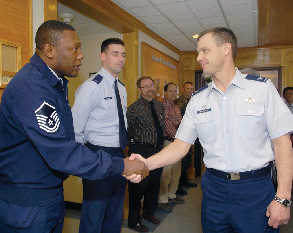 Col. Steven Harrison, 89th Airlift Wing commander, shakes hands with Master Sgt. Stanley Bullock, 316th Civil Engineer Squadron superintendent of the Readiness Flight, during the 89th commander’s tour of the 316th Wing on Monday. The tour included visits to different squadrons including the 316th Security Forces Squadron, 316th Logistics Readiness Squadron and the 1st Helicopter Squadron. (U.S. Air Force photo/Bobby Jones)