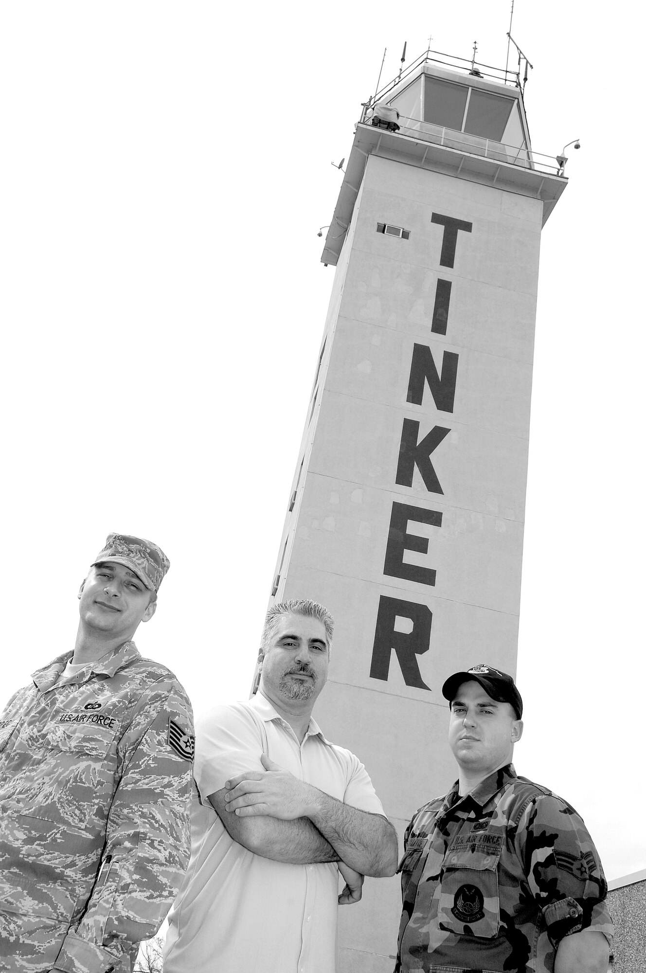 From left: Staff Sgt. David Kopec, Tony Kaczka and Senior Airman Jonathan Chickletts, of the 72nd Operations Support Squadron stand in front of Tinker’s Air Traffic Control Tower where they watch over aircraft arriving and departing the installation and recently helped avert disaster. (Air Force photo/Margo Wright)