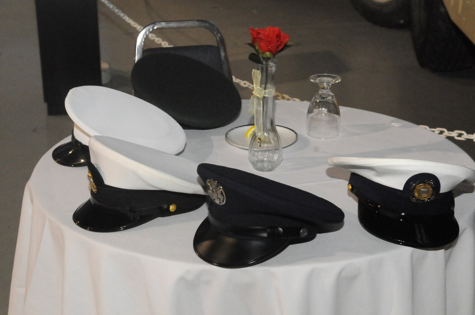 Hats from each service sit on a POW/MIA table at Robins Air Force Base National Prayer Luncheon March 10 at the Museum of Aviation. The event drew a record-breaking crowd of 520 people. U. S. Air Force photo by Sue Sapp