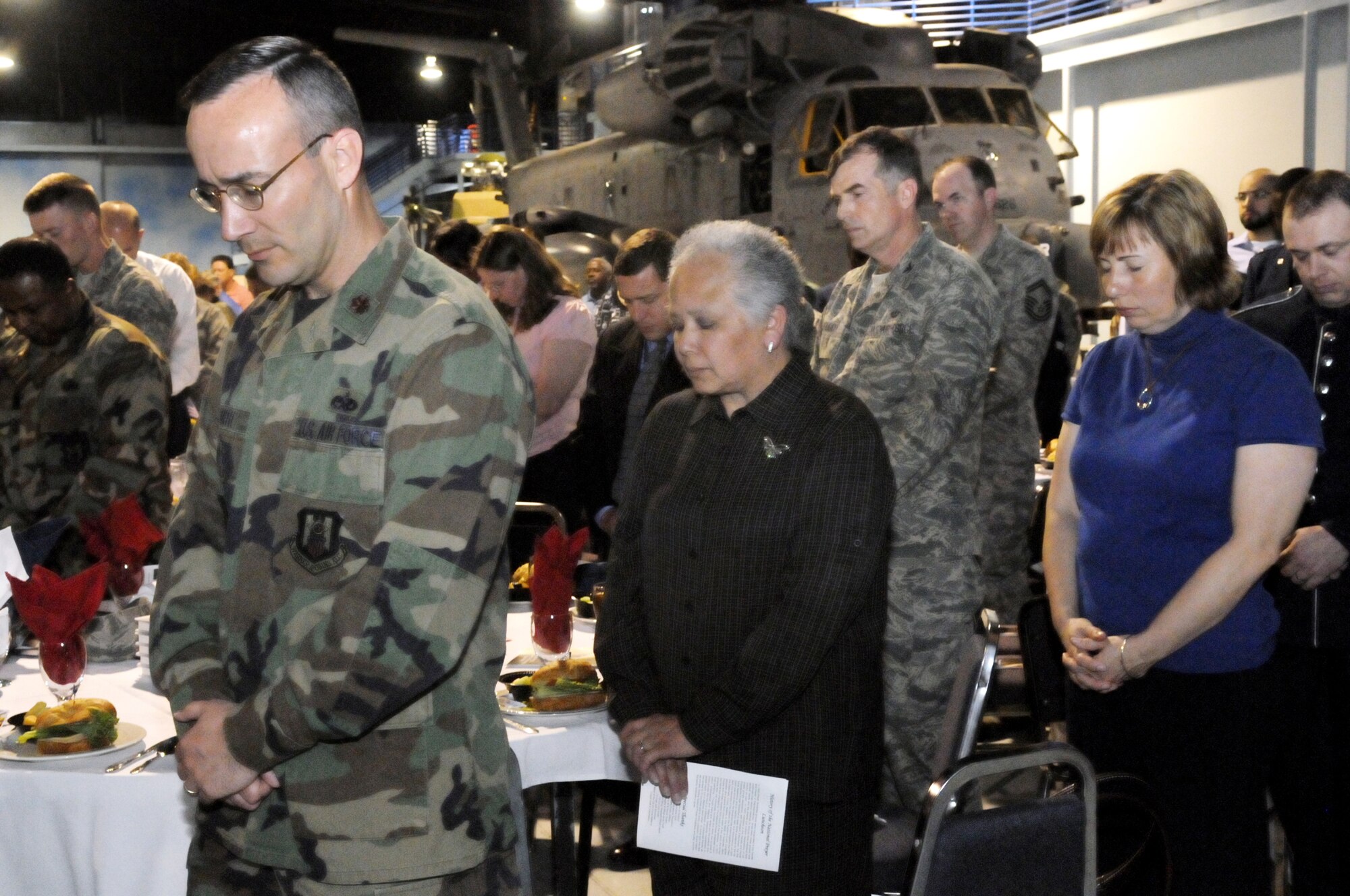 People bow in prayer during the invocation at Robins Air Force Base National Prayer Luncheon March 10 at the Museum of Aviation. U. S. Air Force photo by Sue Sapp
