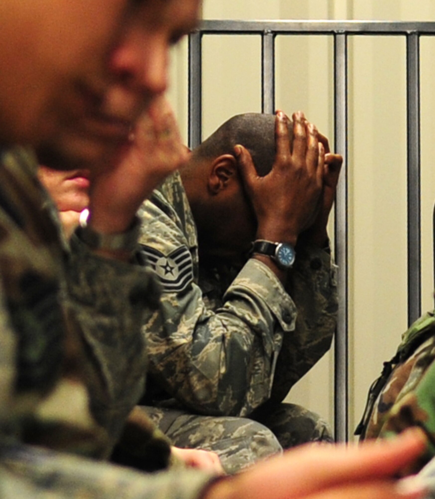 An Airman rests while waiting for a bus during an early-morning training exercise at Seymour Johnson Air Force Base, N.C.,  March 12, 2009. The exercise simulates many of the processes of an actual deployment, which often involves a significant amount of down-time between information briefings and while waiting for transportation. (U.S. Air Force photo by Airman 1st Class Rae A. Perry)  