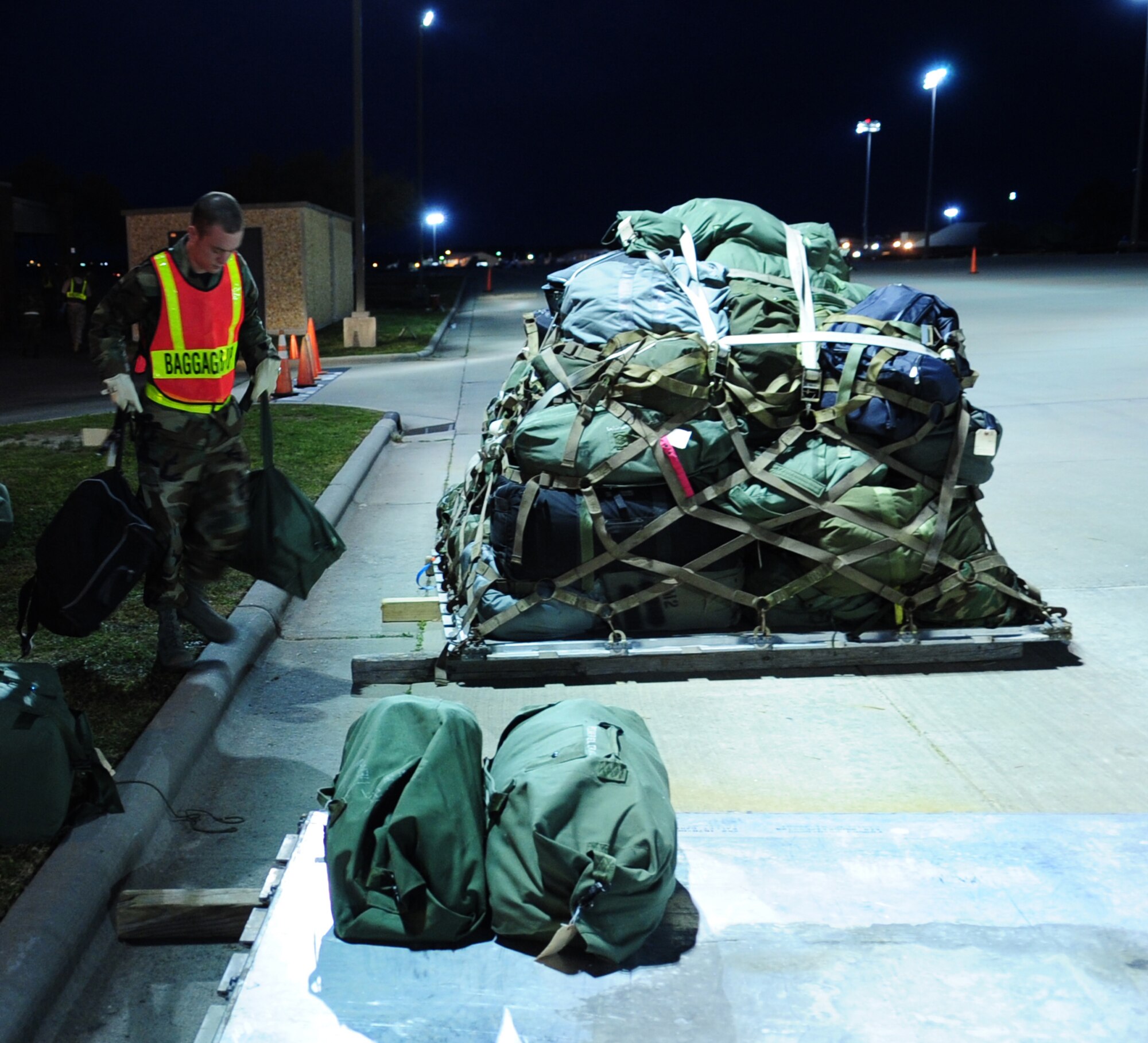 An Airman prepares baggage for transportation during a training exercise at Seymour Johnson Air Force Base, N.C., March 12, 2009. The exercise, which is the first phase of an operational readiness exercise, tests a unit's ability to organize and deploy their Airmen on short notice. As part of the exercise, Airmen packed their bags as if it were an actual deployment. Rapid global mobility, the ability to respond quickly and decisively anywhere needed, is one of the Air Force's distinctive capabilities. (U.S. Air Force Photo by Airman 1st Class Rae A. Perry)