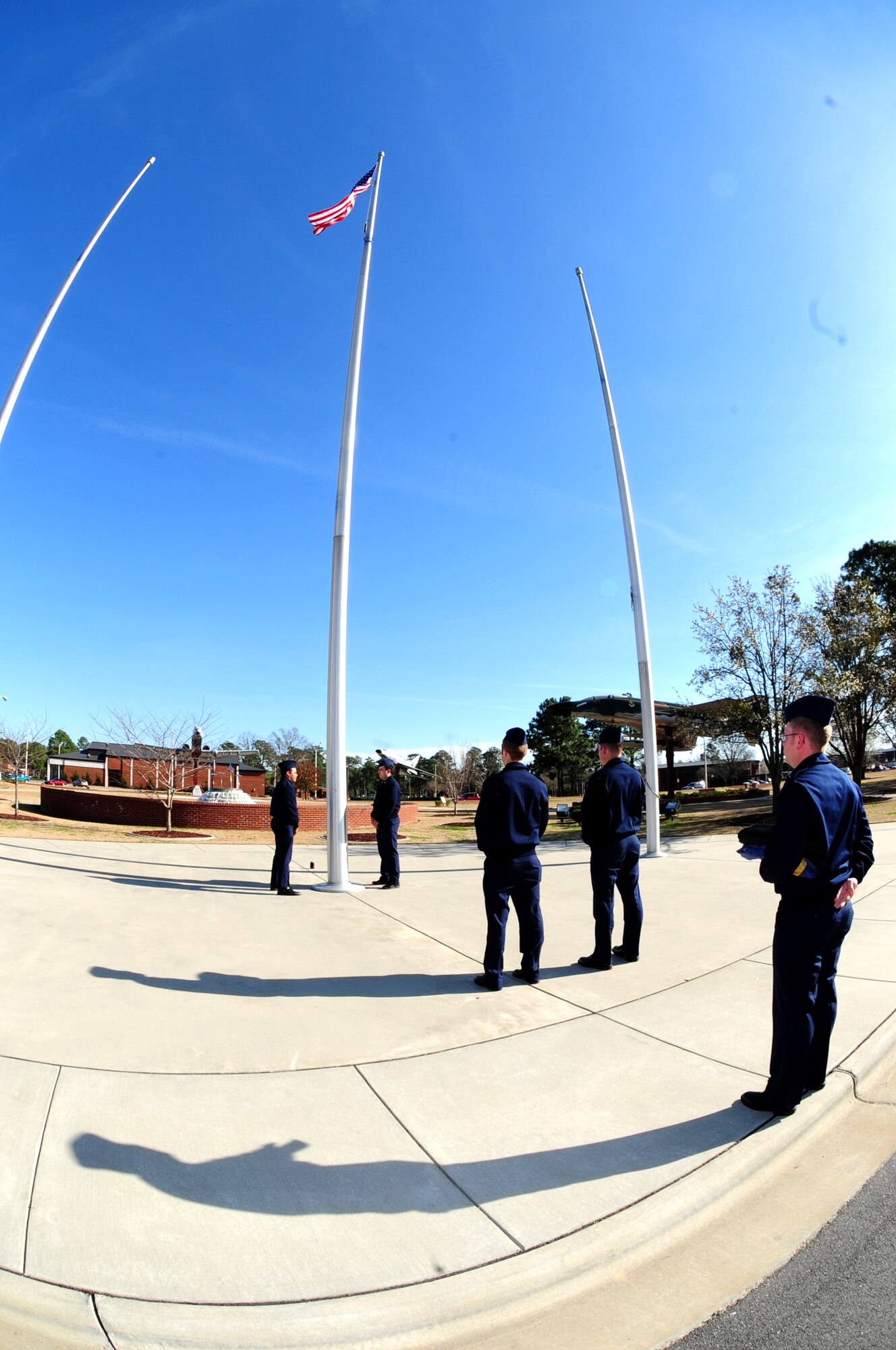 Airmen of the 4th Fighter Wing Base Honor Guard wait for the National Anthem to play before lowering the American flag to complete a retreat ceremony at Seymour Johnson Air Force Base, N.C., March 9, 2009. The retreat ceremony was developed to show respect for a nation's flag. The flag is removed from the pole and folded into a triangle shape that resembles the cocked hat of a soldier from the Revolutionary War. This ceremony is preformed everyday at 4:30 p.m. to signify the end of the work day. (U.S. Air Force Photo by Airman 1st Class Rae A. Perry)
