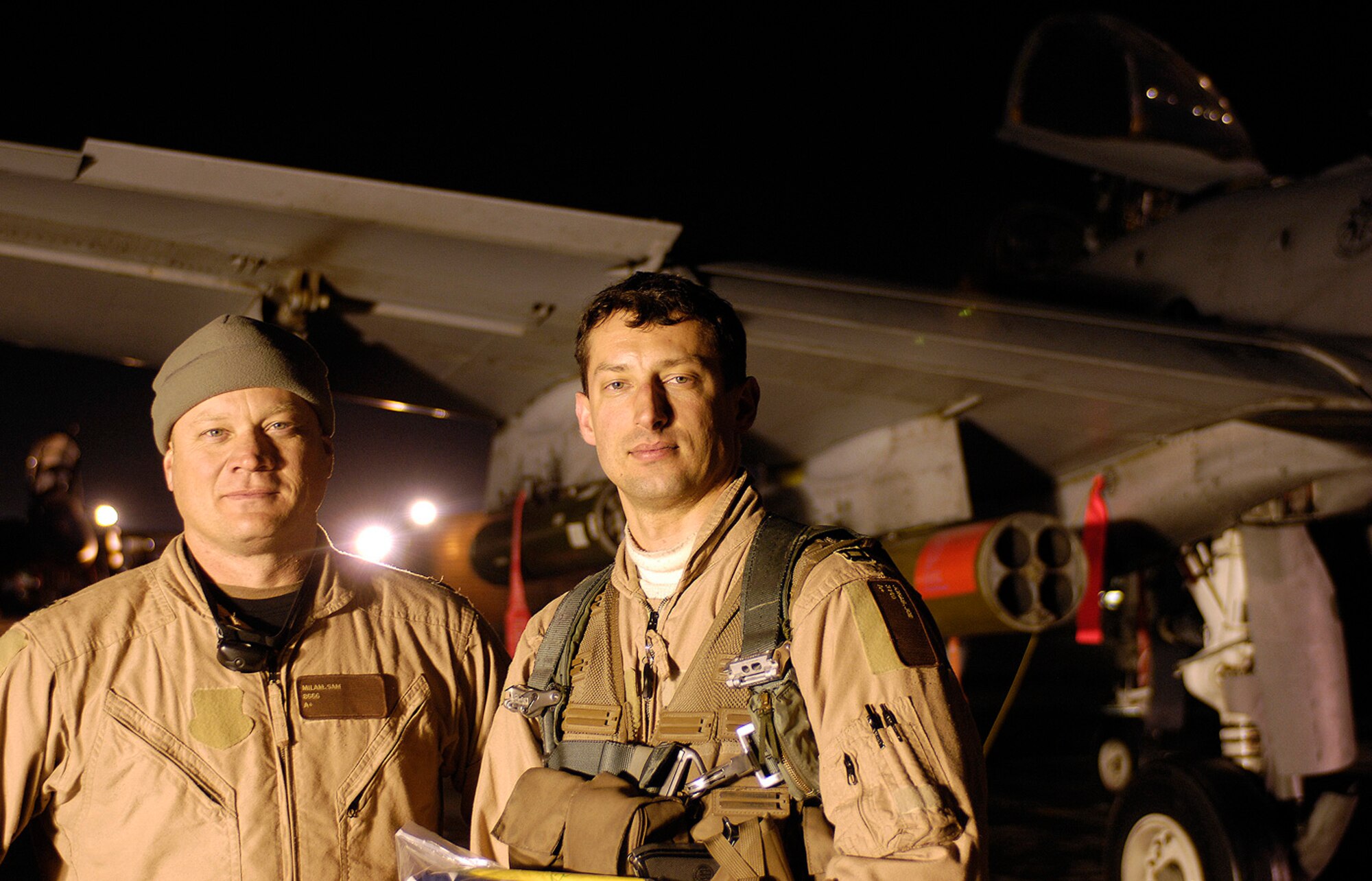 Lt. Col. Sam Milam, 75th Expeditionary Fighter Squadron commander, and Capt. Jozsef Jonas, a 75th EFS pilot, pose for a photo after completing a close air support mission that helped save lives of coalition troops in Afghanistan Feb. 20. The 75th EFS was deployed to Bagram Air Field, Afghanistan, to provide close air support to ground troops and convoys as they tried to improve the quality of life for the Afghan people. Captain Jonas, a Hungarian immigrant who is the son of a Soviet tank driver, flies the A-10 Thunderbolt II "tank killer" for the U.S. Air Force. Colonel Milam also flies the A-10 and recently completed a mission that logged more than 10,000 combat flight hours - a historic milestone for the unit deployed here since last fall. The two pilots, who were deployed here from Moody Air Force Base, Ga., returned home this week after the 75th EFS completed its six-month rotation. The unit was replaced by its sister squadron, the 74th Fighter Squadron, which is also from Moody AFB. 