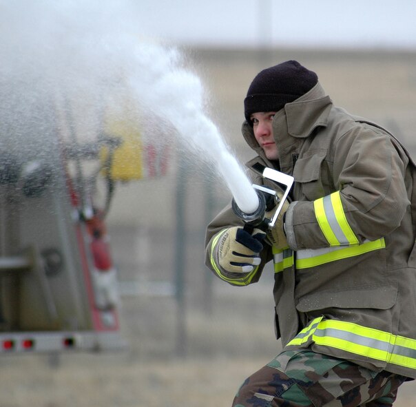 Staff Sgt. Alan Anderson, 341st Civil Engineer Squadron firefighter, sprays foam during a Rapid Intervention Vehicle training session March 5 near the flight line. (U.S. Air Force photo/Senior Airman Dillon White)