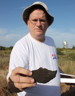 Thomas Penders of the 45th Civil Engineer Squadron holds a piece of ancient pottery uncovered at the Little Midden site at Cape Canaveral Feb. 27. (U.S. Air Force photo/Airman 1st Class David Dobrydney)