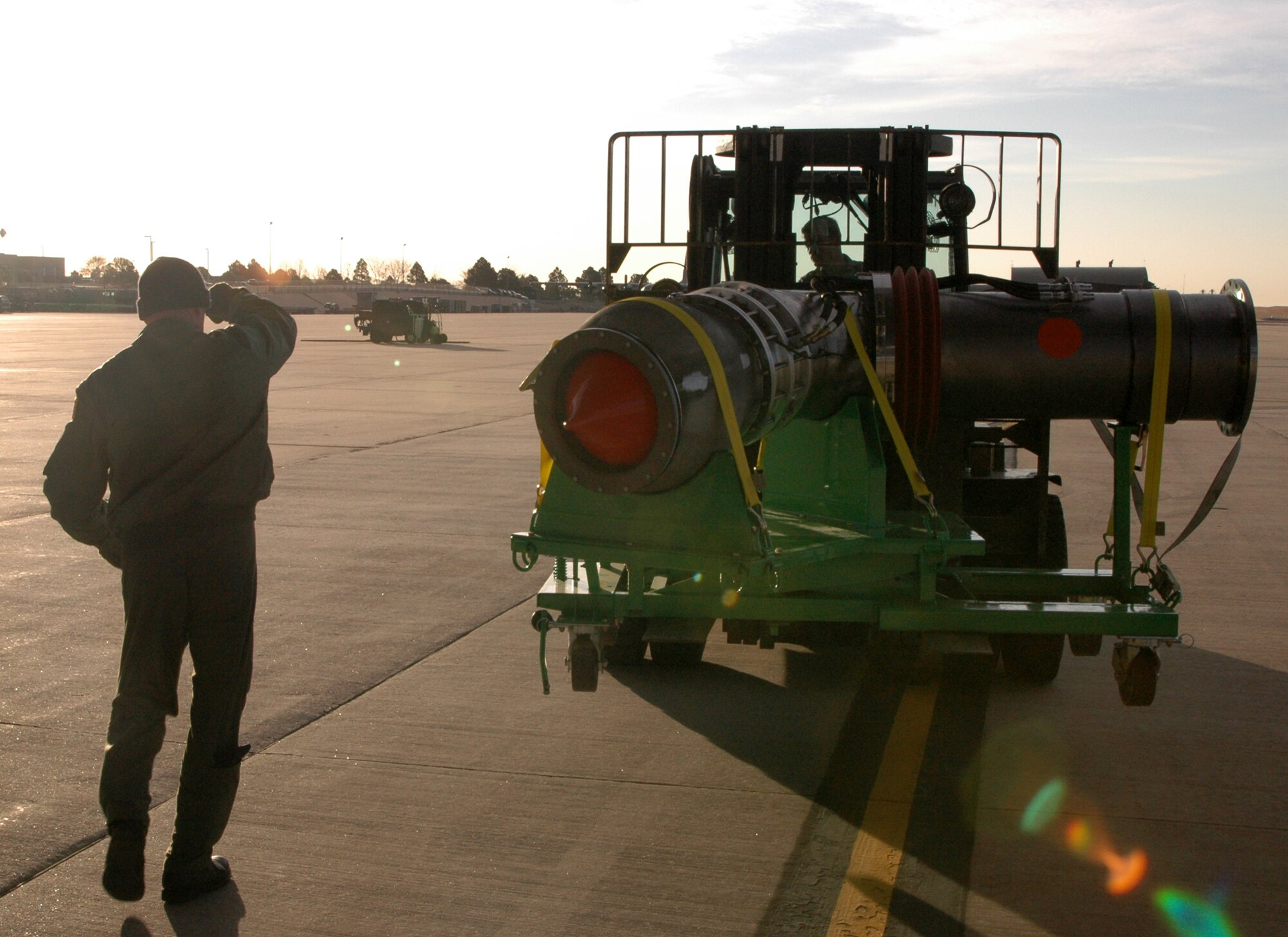 Senior Master Sgt. Derek Ashcraft directs a forklift driver as the nozzle portion of a second-generation Military Airborne Firefighting System unit is offloaded from its C-130 transport March 12, 2009, at Peterson Air Force Base, Colo. Known as MAFFS II, the unit augments the current MAFFS system, but is portable and self contained, making it more cost effective. Over time, MAFFS II will replace existing MAFFS units throughout the military's firefighting fleet supported by three Air National Guard wings as well as the Air Force Reserve's 302nd Airlift Wing at Peterson. Sergeant Ashcraft is a loadmaster with the 731st Airlift Squadron. (U.S. Air Force photo/Senior Airman Stephen Collier)