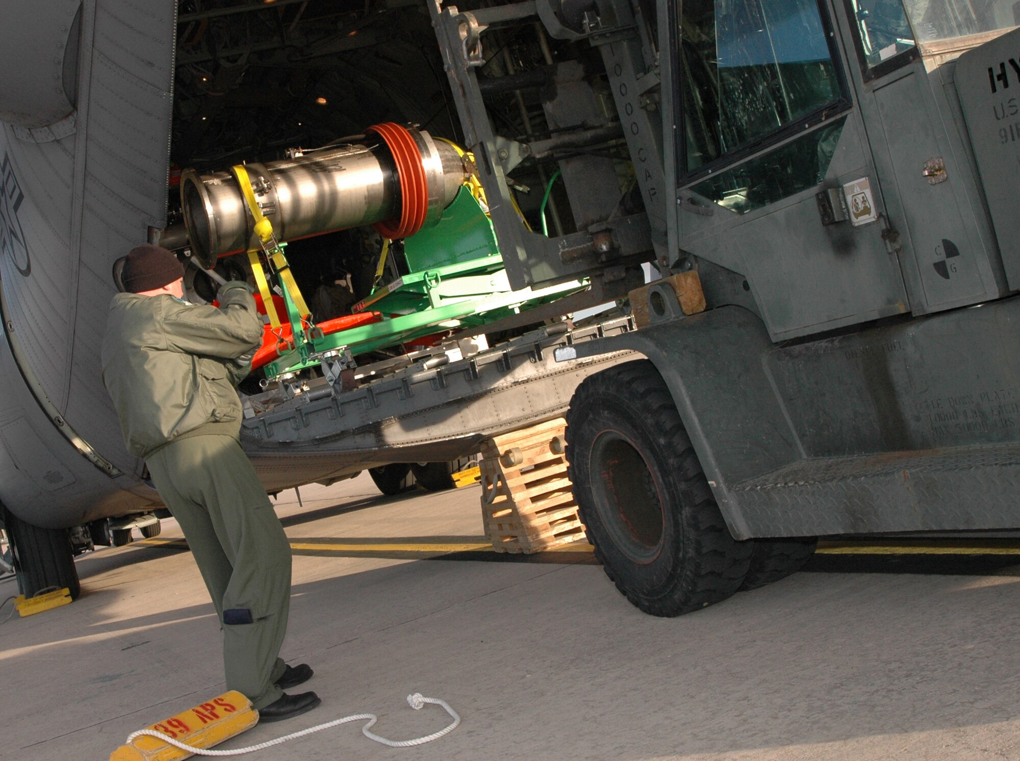 Senior Master Sgt. Derek Ashcraft directs a forklift driver on how to properly remove portions of a second-generation Military Airborne Firefighting System unit March 12, 2009, at Peterson Air Force Base, Colo. Known as MAFFS II, the unit augments the current MAFFS system, but is portable and self contained, making it more cost effective. Over time, MAFFS II will replace existing MAFFS units throughout the military's firefighting fleet supported by three Air National Guard wings as well as the Air Force Reserve's 302nd Airlift Wing at Peterson. Sergeant Ashcraft is a loadmaster with the 731st Airlift Squadron. (U.S. Air Force photo/Senior Airman Stephen Collier)