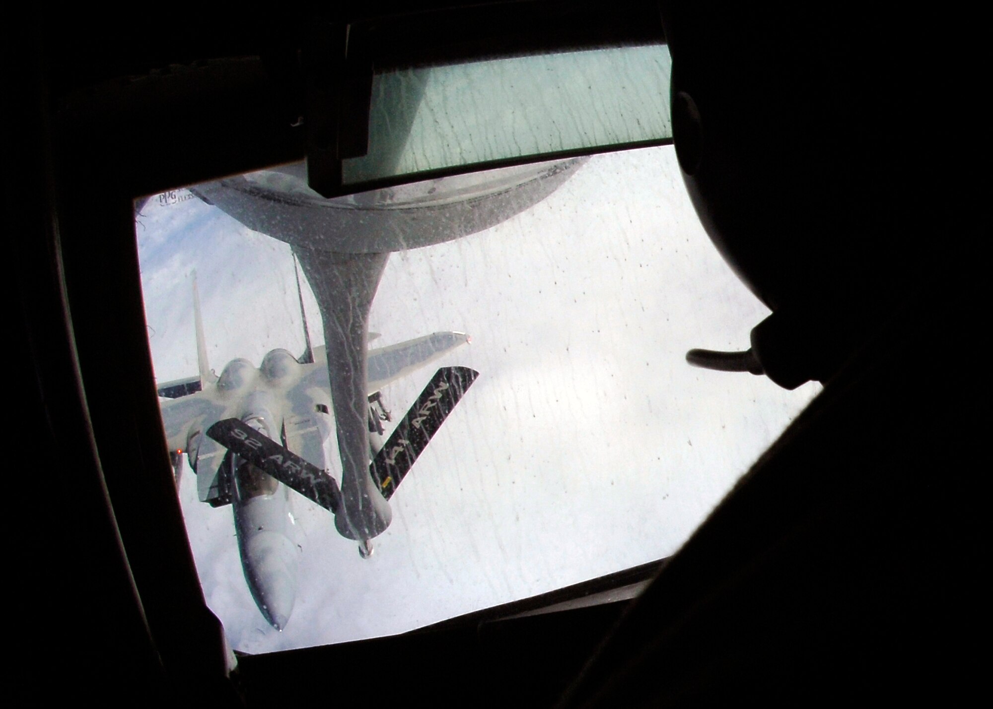Technical Sgt. Theodore Buit, 92nd Air Refueling Squadron boom operator, strategically positions a KC-135 boom over an F-15 to begin refueling over Portland, Ore. on March 5. The Honorary Commanders aboard the tanker were able to watch the refueling by lying down inside the boom. (U.S. Ai r Force photo / Airman 1st Class Melissa L. Barnett)