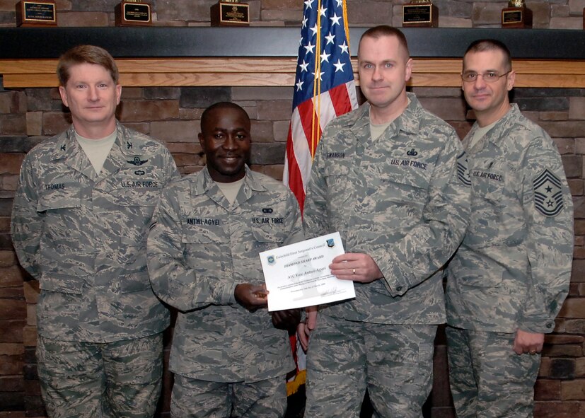 Col. Robert Thomas, 92nd Air Refueling Wing commander, and Chief Master Sgt. David Nordel, 92nd Air Refueling Wing command chief, present Airman 1st Class Yaw Antwi-Agyei, 92nd Communication Squadron knowledge operator, with the Diamond Sharp award during a breakfast at the Warrior Dining Facility on March 10. Airman Antwi-Agyei was nominated by Master Sgt. Robert Swanson, 92nd CS first sergeant, for his motivation to quickly excel in his career and his selflessness for volunteering to help fellow Airmen who are struggling with their fitness. (U.S. Air Force photo / Airman 1st Class Melissa L. Barnett)