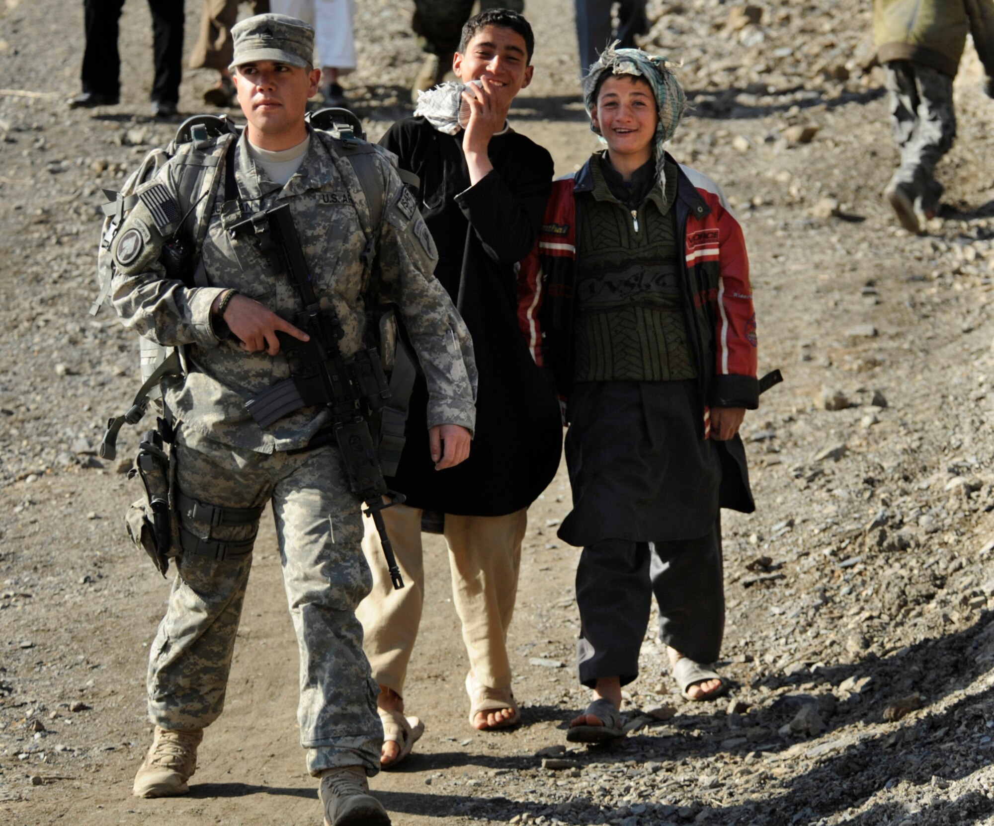 Army Sgt. Ramon Guzman provides security for members of the Panjshir Provincial Reconstruction Team during a March 5 site visit in Afghanistan. Sergeant Guzman is a Panjshir Provincial Reconstruction Team civil affairs member. (U.S. Air Force photo/Staff Sgt. James L. Harper Jr.) 
