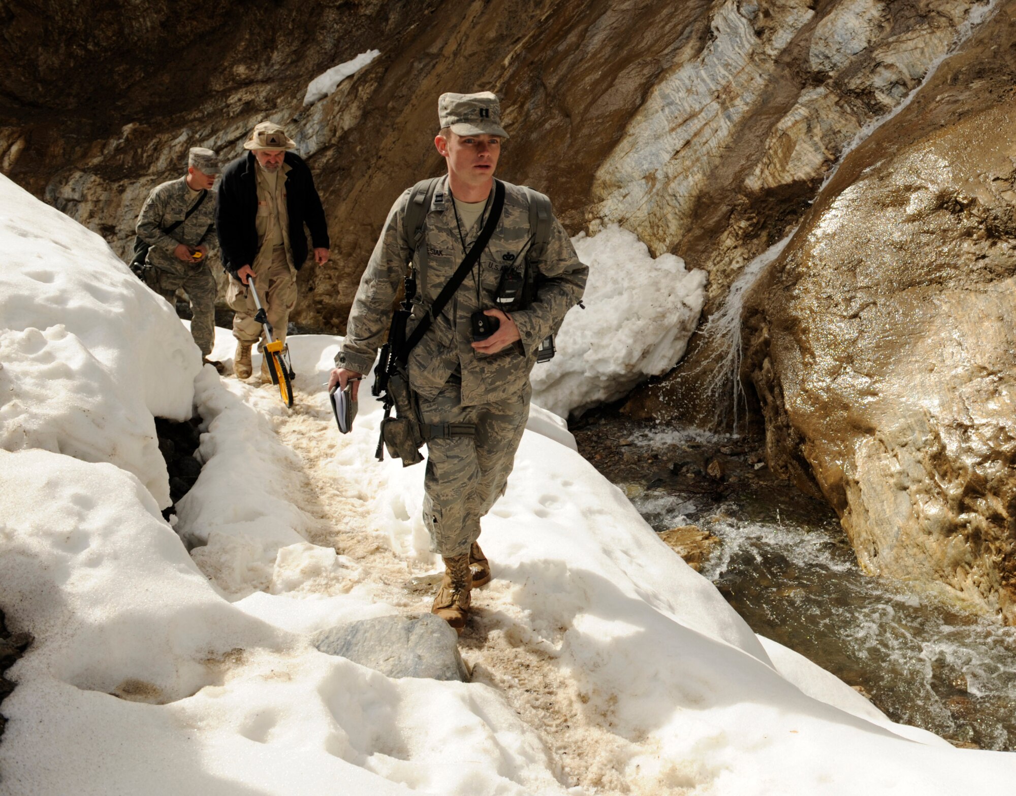 Captain Patrick Kolesiak walks through a valley while surveying for the possibility of constructing a paved road March 4 in Afghanistan's Panjshir Valley. Captain Kolesiak is the Panjshir Provincial Reconstruction Team lead civil engineer. (U.S. Air Force photo/Staff Sgt. James L. Harper Jr.) 
