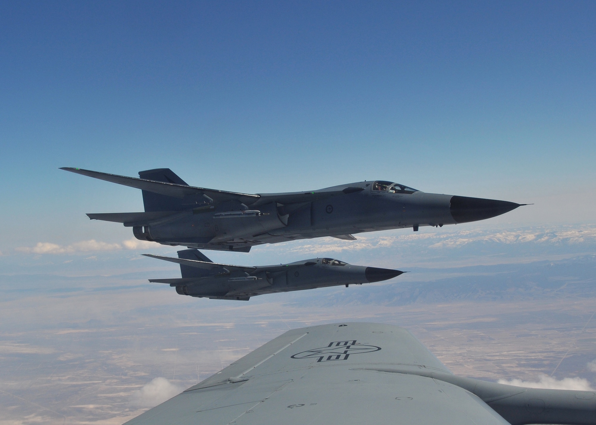 Royal Australian Air Force F-111C fighters from No. 6 Squadron at RAAF Station Amberley, Australia, soar over Nevada during a Red Flag 09-03 mission March 4.  The F-111Cs and their crews provided long-range strike capabilities for the exercise's "Blue" forces.  Aircrews affectionately refer to their F-111s as "Pigs" because of the aircrafts ability to "root out" targets at night and low level.  Red Flag provides realistic combat training for U.S., allied and coalition air forces.  U.S. Air Force photo by Gary Emery  