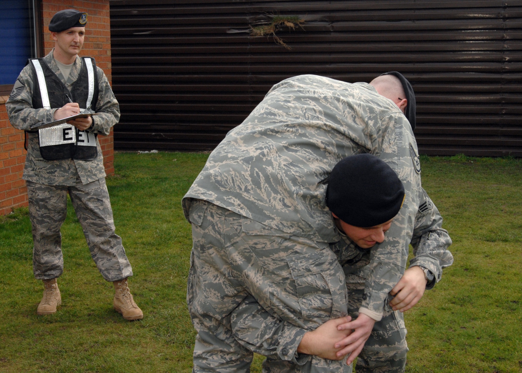 Exercise Evaluation Team member, Master Sgt. John Carter, 100th Security Forces Squadron Standardized Evaluation NCOIC, observes, evaluates and instructs Senior Airman Patrick Gorman, 100th Security Forces Squadron on how to effectively perform the fireman's carry during emergency situations. Master Sgt. Carter is the 100th Air Refueling Wing NCO Annual Award winner and will be competing at United States Air Forces in Europe command level. (U.S Air Force photo by Senior Airman Teresa M. Hawkins)