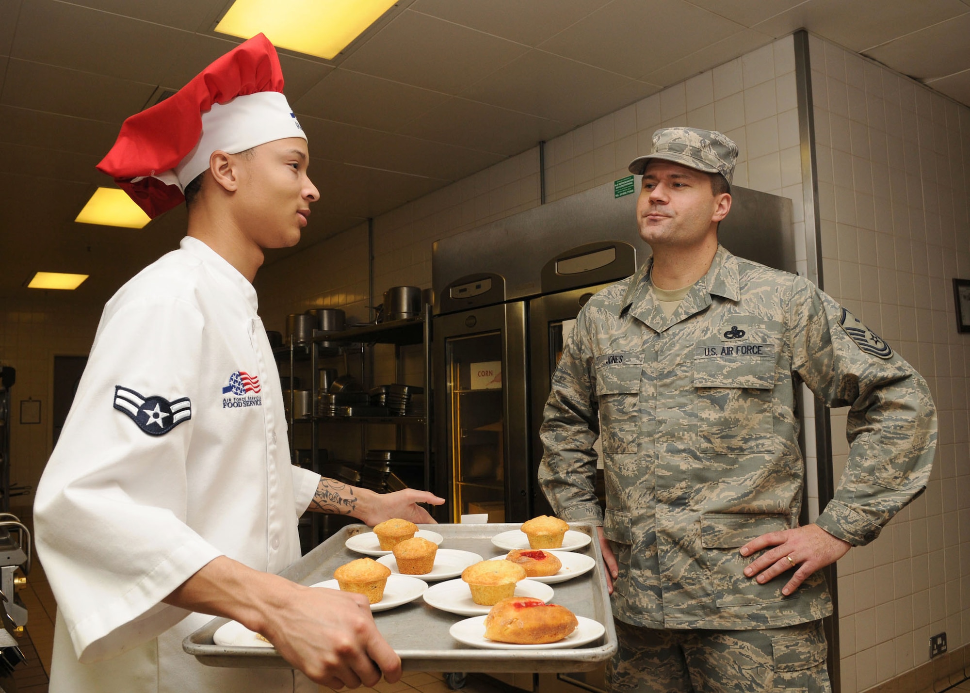 Master Sgt. Beau Jones, 100th Force Support Squadron First Sergeant, speaks with Airman 1st Class Geremy Celestine inside the dining hall kitchen Mar. 3, 2009 at RAF Mildenhall, England. Sergeant Jones recently won the 100th Air Refueling Wing annual award for the First Sergeant Category for 2008.  Sgt. Jones is responsible for the morale, welfare, and conduct of all the enlisted members in a squadron while also advising the commander on a wide range of topics impacting Airman. (U.S. Air Force photo by Staff Sgt. Jerry Fleshman) 