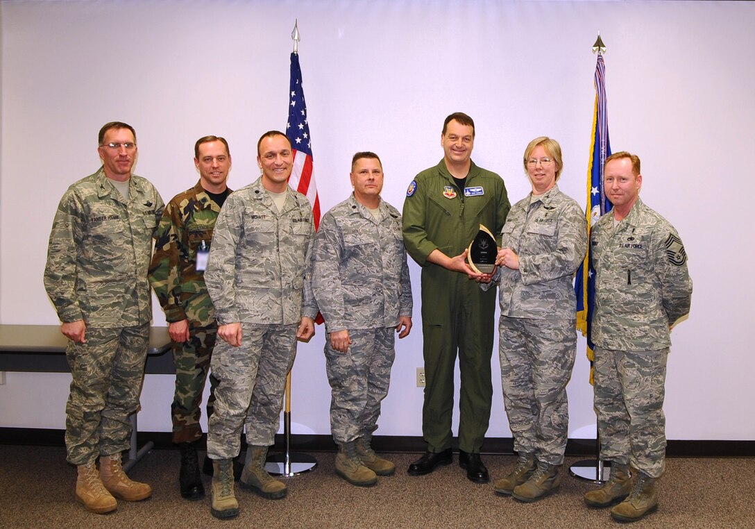 Col. Naomi Boss (second from the right), 28th Medical Group commander, accepts the Air Combat Command Best Medical Clinic of the Year Award from Col. Kory Cornum (third from the right), ACC surgeon general, and Chief Master Sgt. John Murray (right), ACC medical enlisted force chief. The awards recognize Ellsworth healthcare providers in a range of specialties, ranks and accomplishments; many of whom spearheaded important programs, changes in their sections and volunteered their time to the local community. The award recognizes Ellsworth healthcare providers in a range of specialties, ranks, and accomplishments during 2008. From left to right: Col. Scott Vander Hamm, 28th Bomb Wing commander, Lt. Col. John Lynch, 28th Medical Group medical staff chief, Lt. Col. Jon Mohatt, 28th Medical Support Squadron commander, Lt. Col. David Roll, 28th Medical Operations Squadron commander, Colonel Cornum, Colonel Boss, and Chief Murray. (U.S. Air Force photo/Senior Airman Kasey Zickmund)