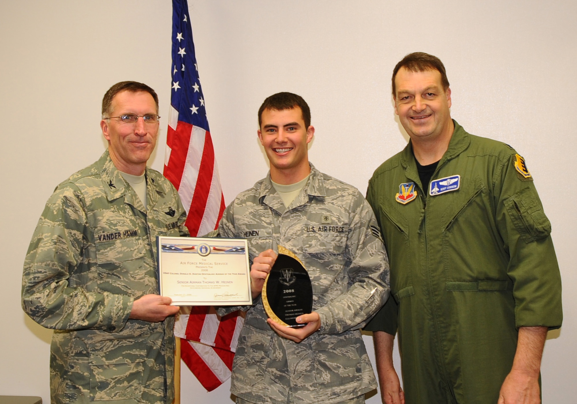 Senior Airman Thomas Heinen, 28th Medical Operations Squadron optometry journeyman, receives the Air Force's and Air Combat Command's USAF Col. Donald D. Dunton Ophthalmic Airman of the Year from Col. Scott Vander Hamm (left), 28th Bomb Wing commander, and Col. Kory Cornum, ACC surgeon general. The awards recognize Ellsworth healthcare providers in a range of specialties, ranks and accomplishments; many of whom spearheaded important programs, changes in their sections and volunteered their time to the local community. (U.S. Air Force photo/Senior Airman Kasey Zickmund)