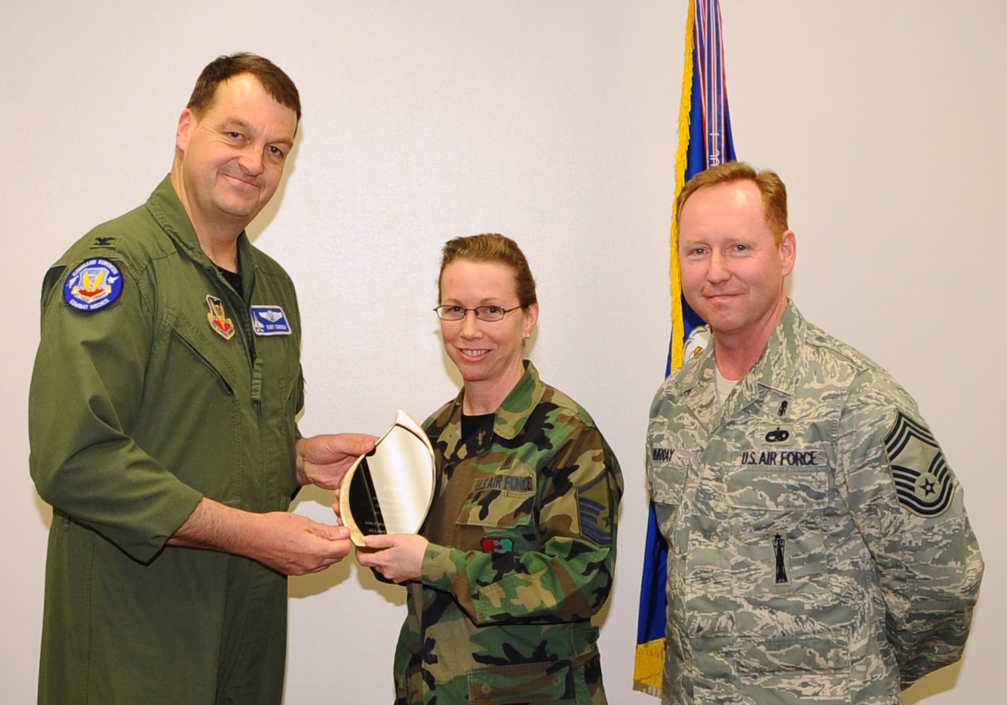 Master Sgt. Jessica Nester, 28th Medical Support Squadron pharmacy flight NCO in-charge, receives the Air Combat Command Pharmacy Technician of the Year Award from Col. Kory Cornum (left), ACC surgeon general, and Chief Master Sgt. John Murray, ACC medical enlisted force chief, March 3. The awards recognize Ellsworth healthcare providers in a range of specialties, ranks and accomplishments; many of whom spearheaded important programs, changes in their sections and volunteered their time to the local community. (U.S. Air Force photo/Senior Airman Kasey Zickmund)