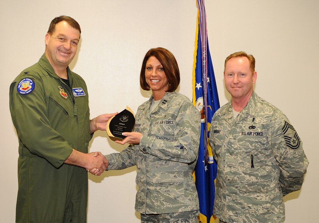 Capt. Kasey Jackson (center), 28th Medical Support Squadron clinical laboratory flight commander, receives the Air Combat Command Clinical Laboratory Manager of the Year Award from Col. Kory Cornum (left), ACC surgeon general, and Chief Master Sgt. John Murray (right), ACC medical enlisted force chief, March 3. The awards recognize Ellsworth healthcare providers in a range of specialties, ranks and accomplishments; many of whom spearheaded important programs, changes in their sections and volunteered their time to the local community. (U.S. Air Force photo/Senior Airman Kasey Zickmund)