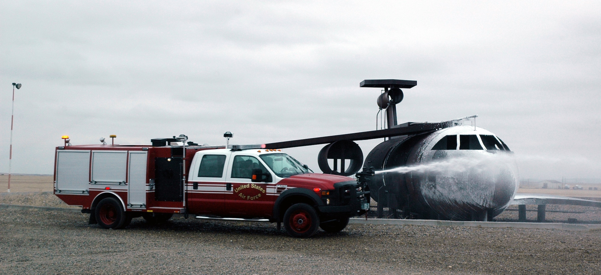 Malmstrom firefighters run the new Rapid Intervention Vehicle through revolutions around a mock aircraft during a training session March 5. The RIV arrived here Feb. 23 to provide aircraft rescue firefighting capability in accordance with National Fire Protection Association standards. (U.S. Air Force photo/Senior Airman Dillon White)