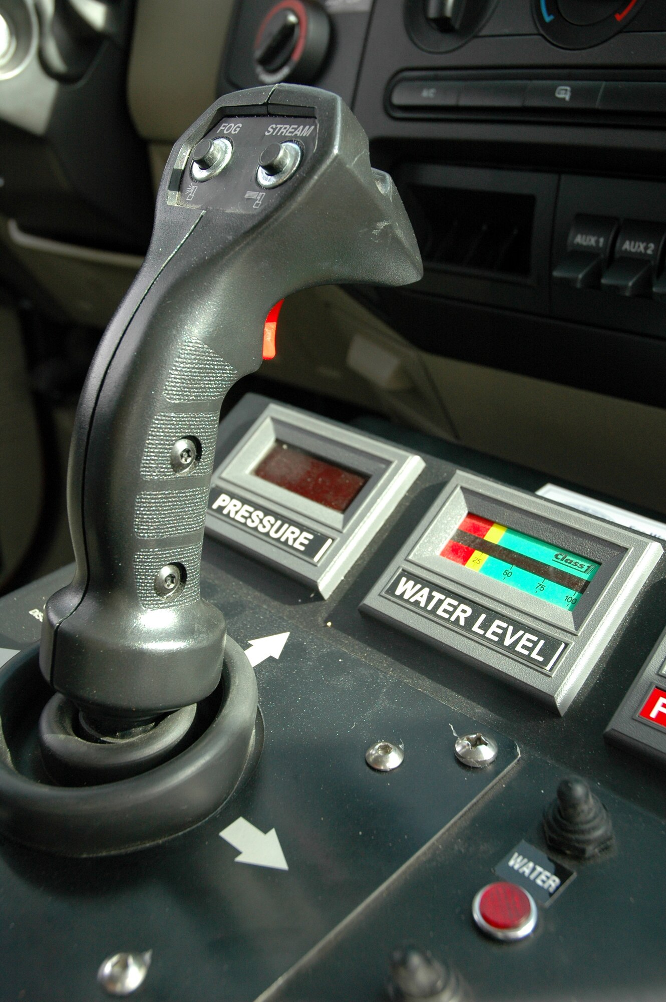 The fighter joystick found in the interior of Malmstrom Air Force Base fire department's new Rapid Intervention Vehicle. The stick controls a bumper-mounted turret capable of dispensing dry chemical, foam or water on aircraft fires.  Malmstrom AFB and F.E. Warren AFB, Wyo., are the first two bases in the Air Force to receive the vehicles, which will support helicopter operations. (U.S. Air Force photo/Senior Airman Dillon White)