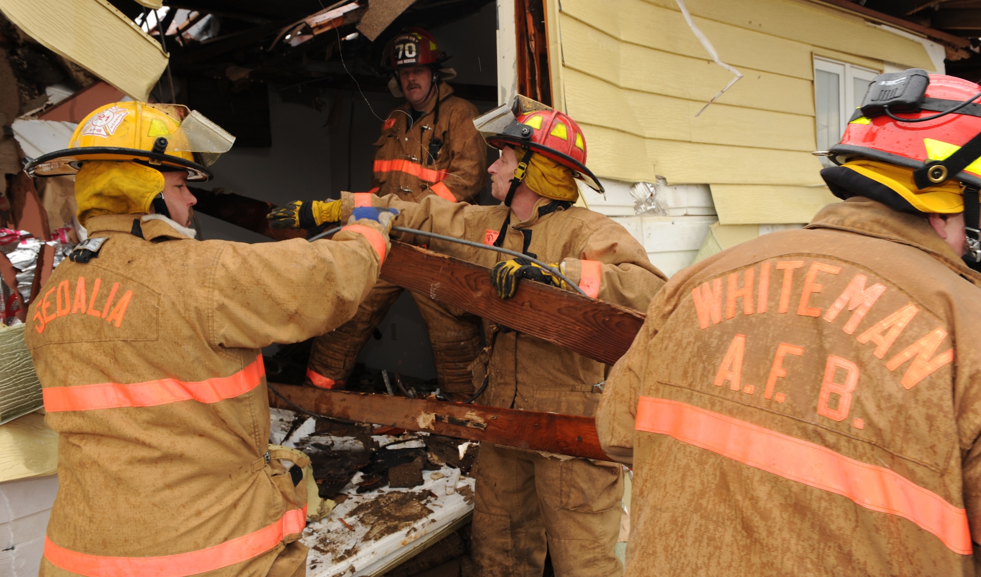 WHITEMAN AIR FORCE BASE, Mo. – Firefighters from here and Sedalia, Mo., move debris in search of survivors during a Major Accident Response Exercise March 10. The MARE focused on natural disaster preparedness and response. Dummies simulating victims where placed inside the buildings that were already slated for demolition. (U.S. Air Force photo/Airman 1st Class Carlin Leslie)