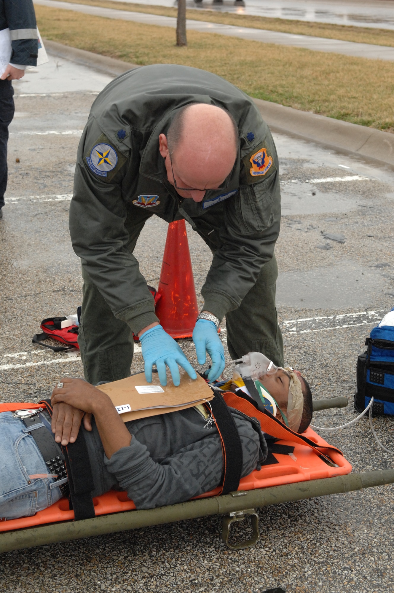 WHITEMAN AIR FORCE BASE, Mo. - Lt. Col. Bruce Woodford, 509th Medical Operations Squadron, provides medical care to a victim during a Major Accident Response Exercise March 10. The MARE was conducted base-wide excluding Whiteman Elementary School and any personnel directly involved with flying operations. (U.S. Air Force photo/Senior Airman Cory Todd)