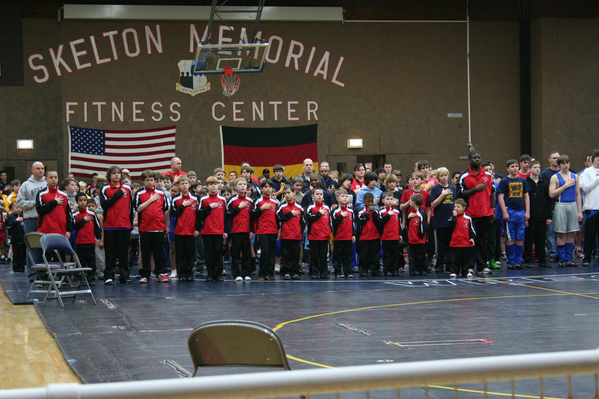 SPANGDAHLEM AIR BASE, Germany -- The Spangdahlem team renders courtesies during the opening ceremonies of the Spangdahlem Sabers Wrestling Tournament held at the Skelton Memorial Fitness Center March 7, 2009.  Children, ages 5-18, from schools throughout U.S. Air Forces Europe competed in the tournament.  (Courtesy photo)  
