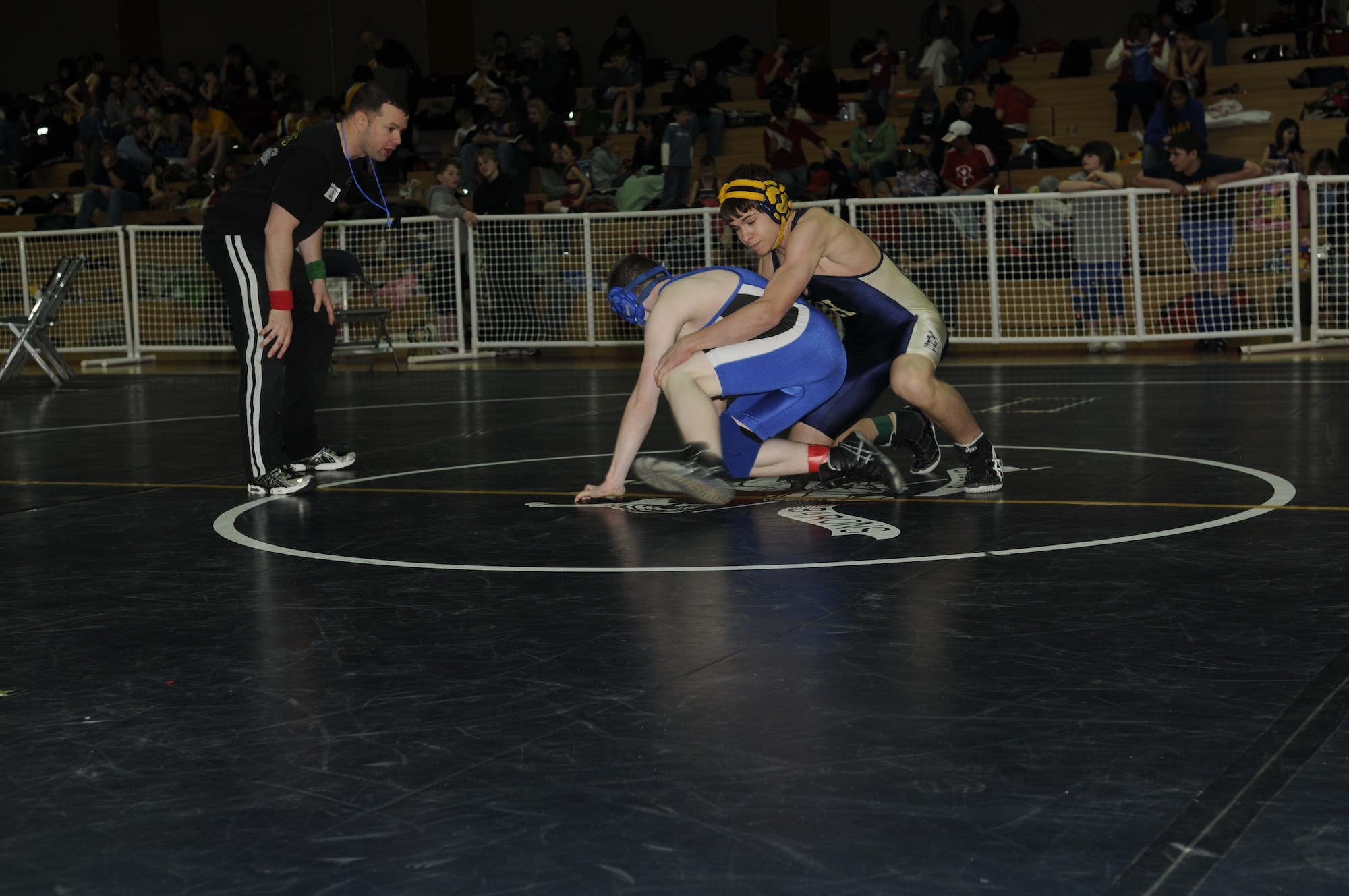SPANGDAHLEM AIR BASE, Germany -- Competitors struggle during a match to gain advantageous positions March 7, 2009.  Children, ages 5-18, from schools throughout U.S. Air Forces Europe competed in the Spangdahlem Sabers Wrestling Tournament at the Skelton Memorial Fitness Center.  (U.S. Air Force photo by Senior Airman Allen Pollard)