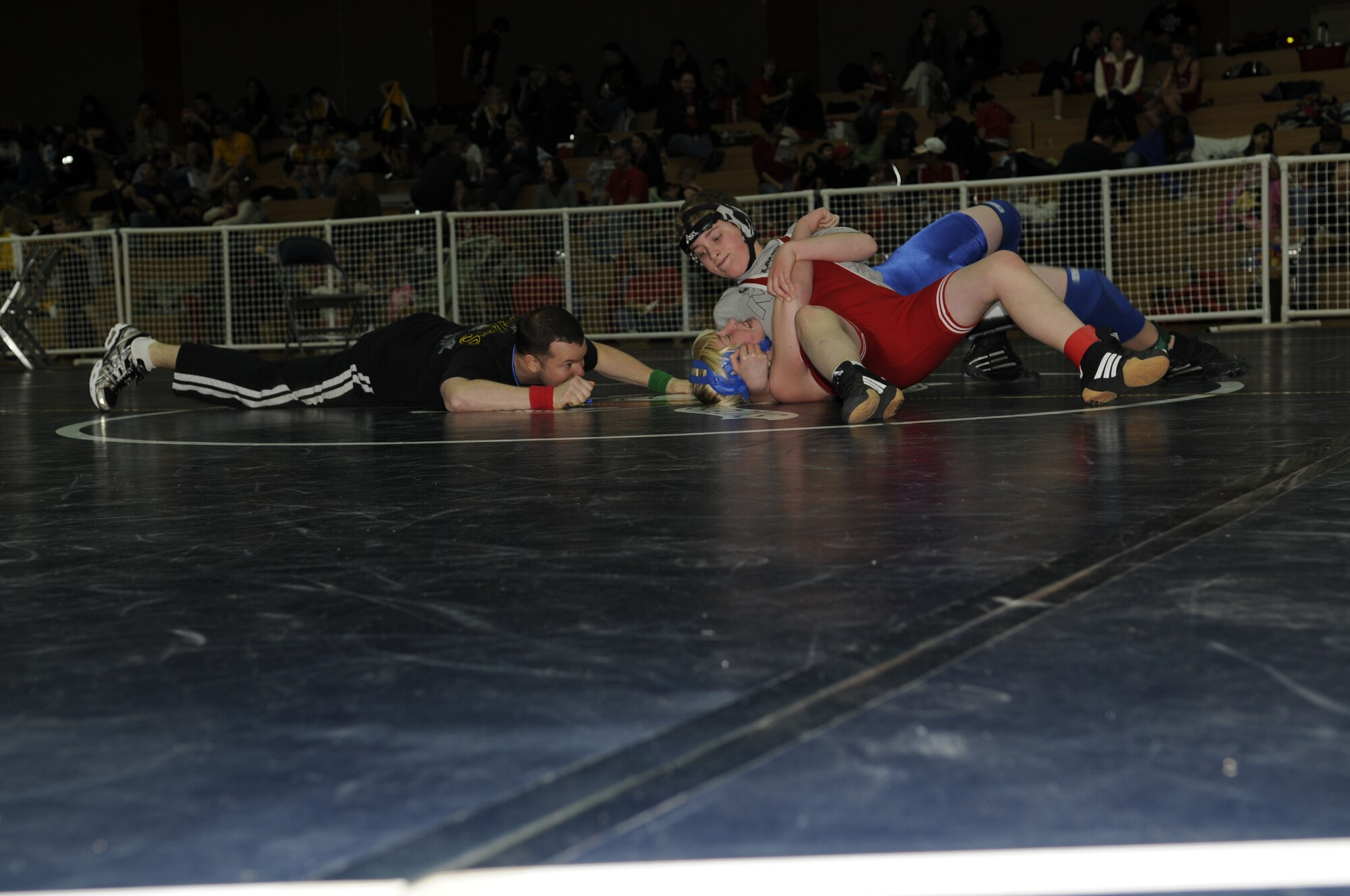 SPANGDAHLEM AIR BASE, Germany -- Capt. Dennis Lincoln, 52nd Operations Group, observes two competitors during a wrestling match held at the Skelton Memorial Fitness Center March 7, 2009.  Children, ages 5-18, from schools throughout U.S. Air Forces Europe competed in the Spangdahlem Sabers Wrestling Tournament.  (U.S. Air Force photo by Senior Airman Allen Pollard)  