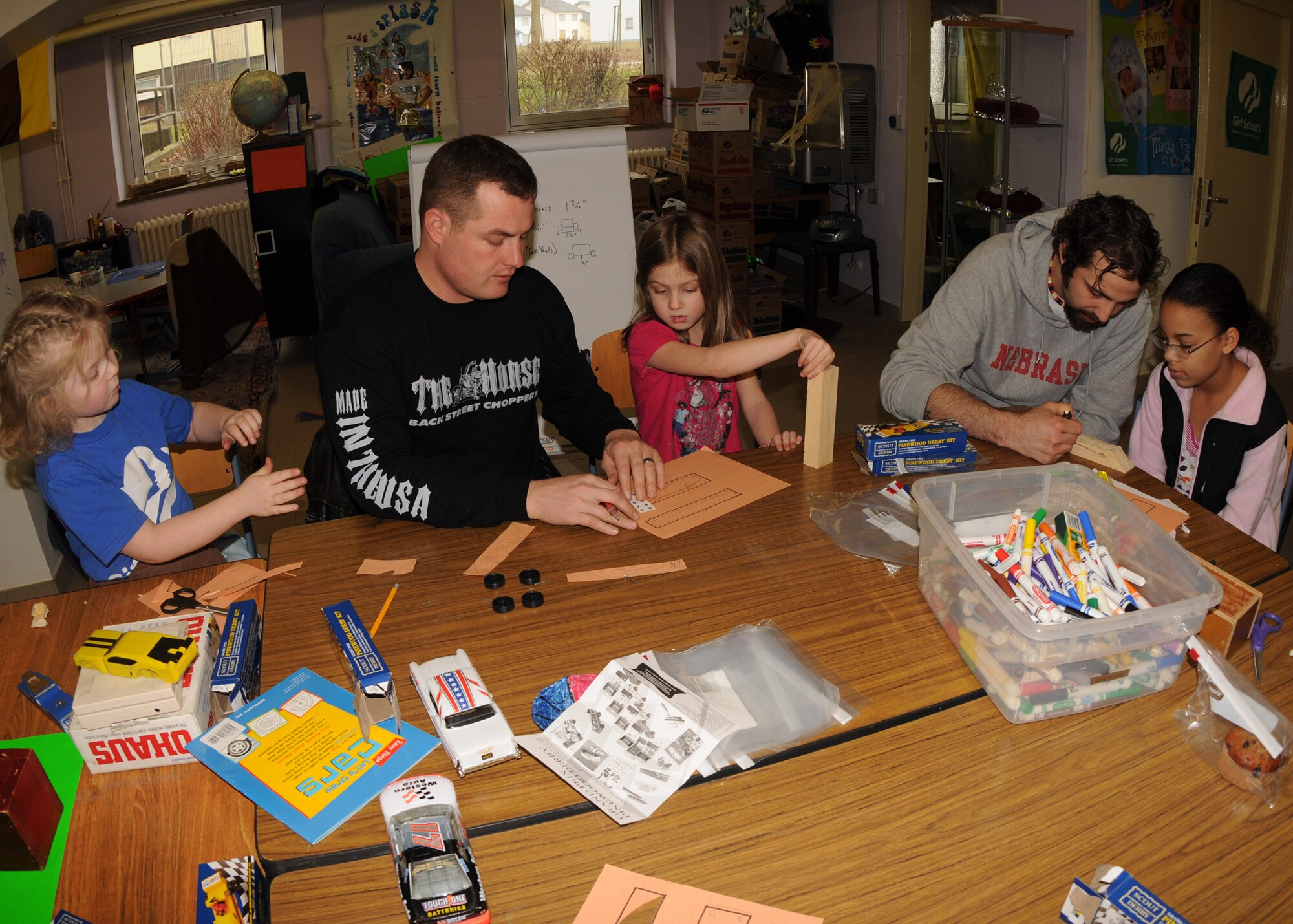 SPANGDAHLEM AIR BASE, Germany -- A group of Saber Girl Scouts and volunteers draw out designs for their Pinewood Derby cars March 7, 2009. The Girl Scouts were given two days to prepare for the Pinewood Derby that takes place March 21, 2009. (U.S. Air Force photo by Airman 1st Class Nicholas Wilson)