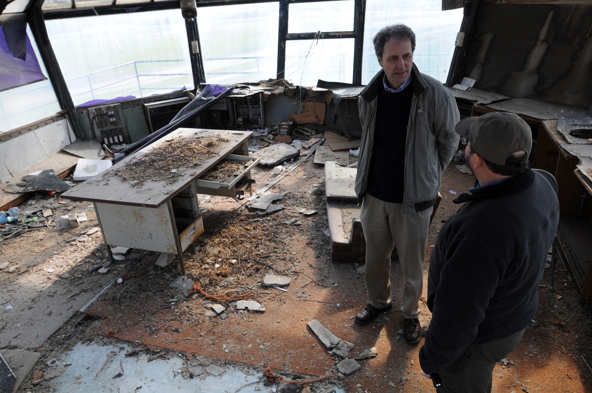 Bill Harris (wearing hat), 48th Fighter Wing Historian discusses some of the intricate details of the old air traffic control tower here with Joe Koziar, a fourth-grade school teacher at Feltwell Elementary School. They were taking a final look Feb. 27, 2009 to document the building before it’s demolished. The tower has fell into disarray since being abandoned in 1992. (U.S. Air Force photo by Staff Sgt. Nathan Gallahan)