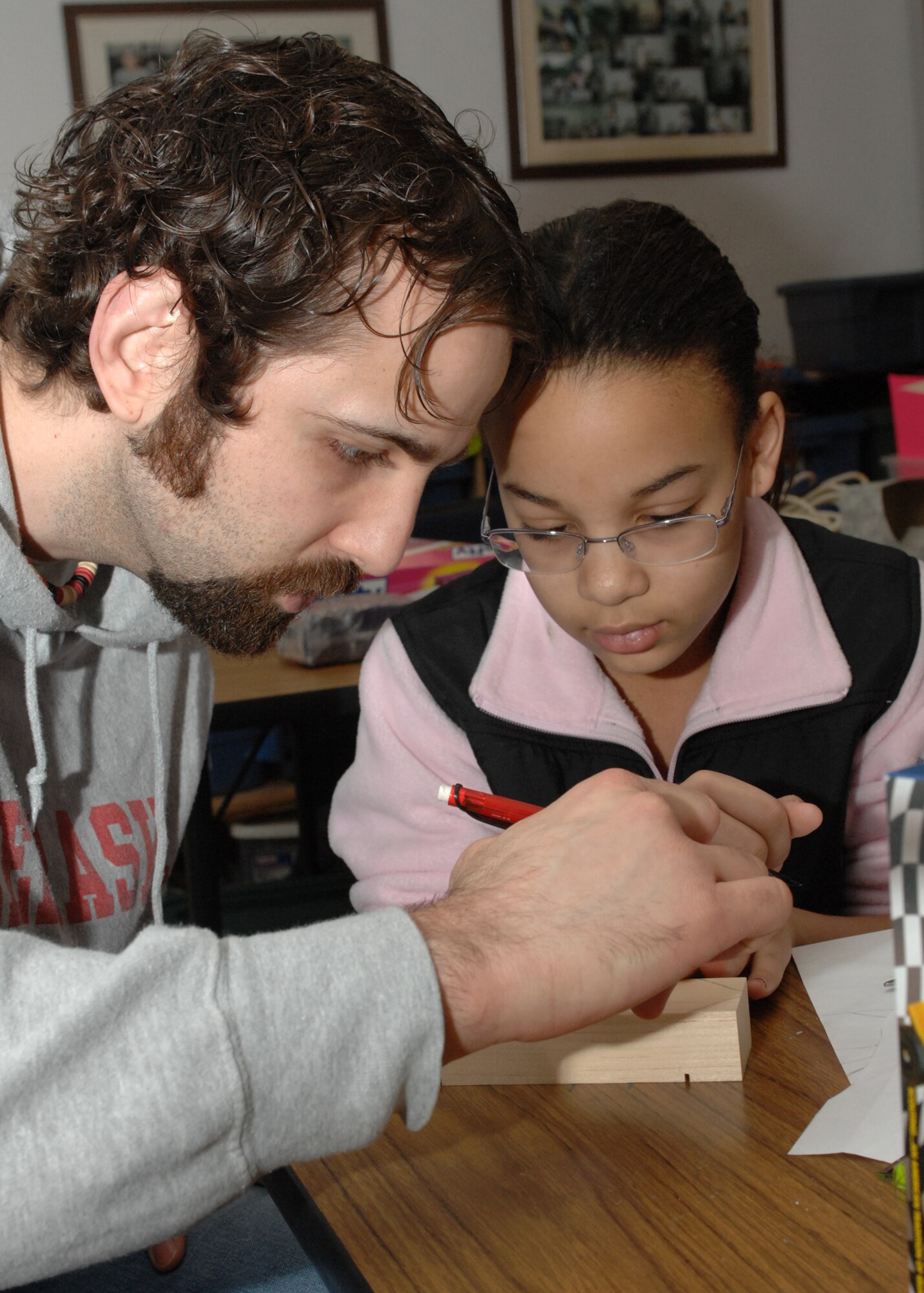 SPANGDAHELM AIR BASE, Germany -- A father and daughter share a bonding experience as they work together building her Pinewood Derby car Feb. 28, 2009.  The Pinewood Derby will be held March 21, 2009. (U.S. Air Force photo by Senior Airman Jenifer H. Calhoun)