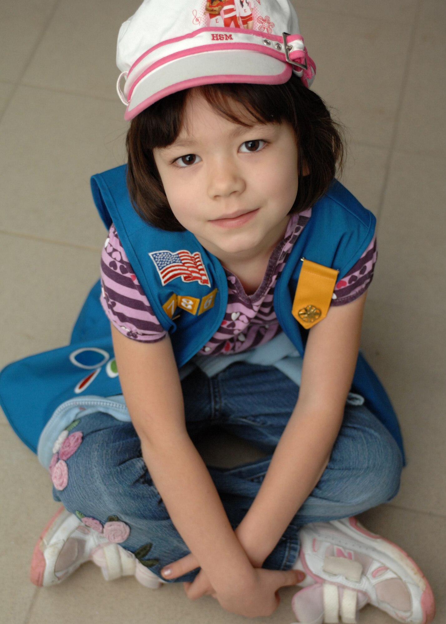 SPANGDAHELM AIR BASE, Germany -- Emiko Groder, daughter of Master Sgt. Michael and Kimberlee Groder, 52nd Security Forces Squadron, takes a break from building her Pinewood Derby car Feb. 28, 2009.  The Spangdahlem Girl Scouts joined together and made cars in preparation for the Pinewood Derby that takes place March 21, 2009. (U.S. Air Force photo by Senior Airman Jenifer H. Calhoun)