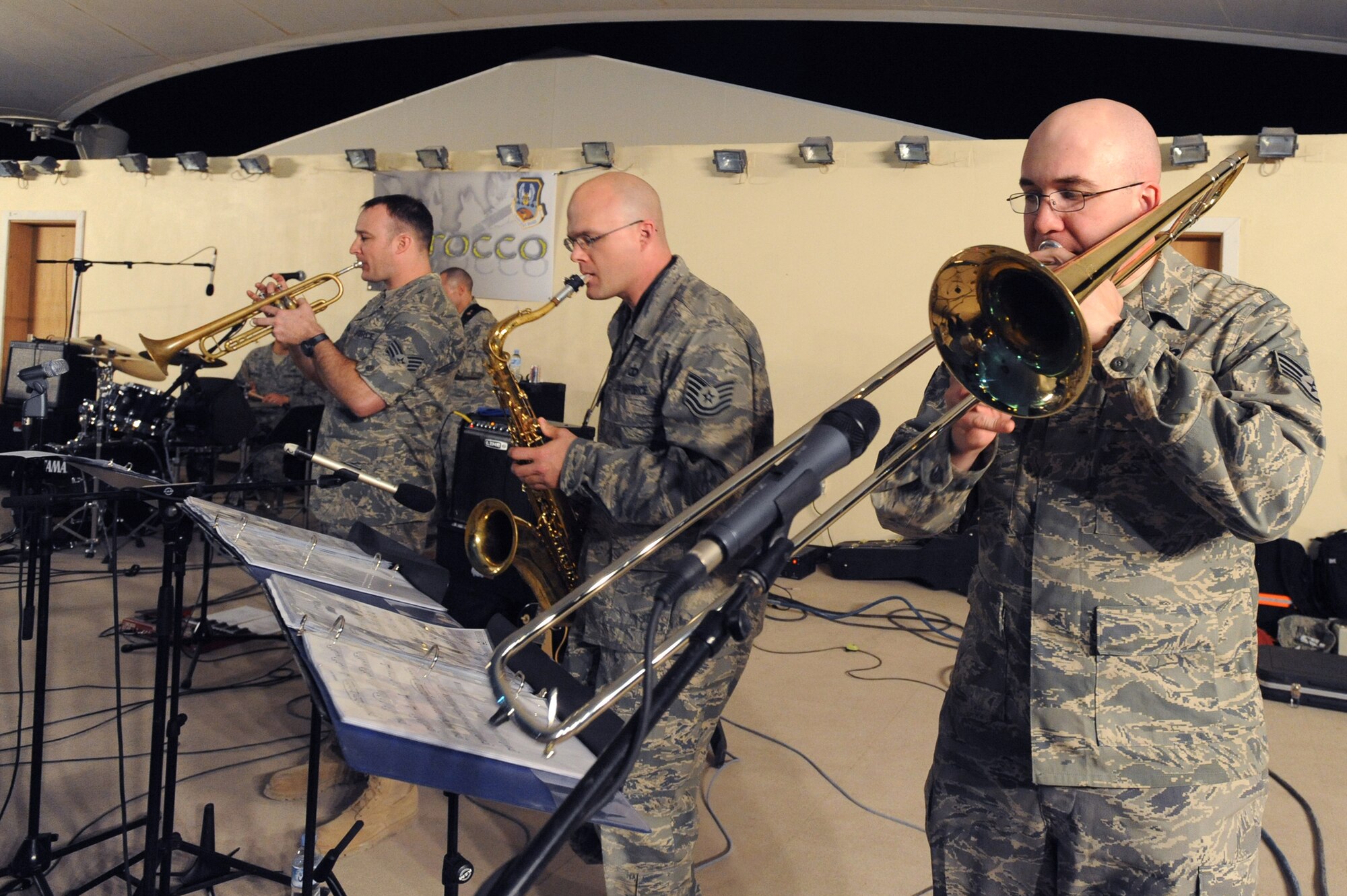 Staff  Sgt. Lonnie Dooley plays trumpet, Tech. Sgt. Jeffrey Saunders plays saxophone, and Staff Sgt. Frank Gourley plays trombone for the AFCENT Band Sirocco, as they perform here, March 9, 2009, in an undisclosed location in Southwest Asia.  Sirocco travels throughout the U.S. Central Command's area of responsibility performing for deployed servicemembers.  Sergeant Dooley is from Graham, Texas, Sergeant Saunders is native to Binghamton, N.Y., and Sergeant Gourley is from Duluth, Minn.  All members are deployed from Sembach Air Base, Germany in support of Operations Iraqi and Enduring Freedom and Combined Joint Task Force - Horn of Africa.  (U.S. Air Force Photo by Staff Sgt. Joshua Garcia/released)  	
