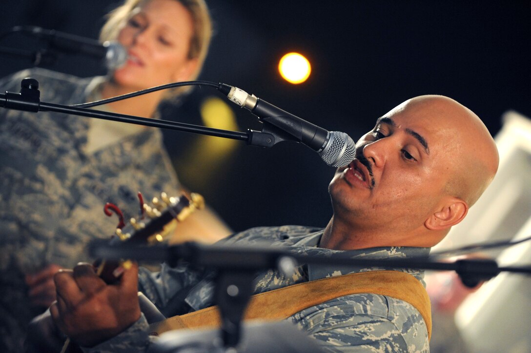Tech. Sgt. Eric Rozet, Noncommissioned Officer in Charge of Immigrations for the 379th Air Expeditionary Wing, sings a rendition of "I'm Yours", by Jason Mraz, during a performance with the AFCENT band, Sirocco, March 9, 2009, in an undisclosed location in Southwest Asia.  Sergeant Rozet was invited by the band to join in and has been playing the guitar and singing since high school.  Sergeant Rozet is native to Waianae, Hawaii and is deployed from the U.S. Air Force Academy, Colo. in support of Operations Iraqi and Enduring Freedom and Combined Joint Task Force - Horn of Africa. (U.S. Air Force Photo by Staff Sgt. Joshua Garcia/released)