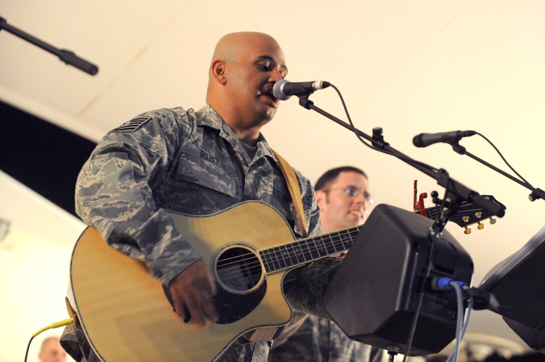 Tech. Sgt. Eric Rozet, Noncommissioned Officer in Charge of Immigrations for the 379th Air Expeditionary Wing, sings a rendition of "I'm Yours" by Jason Mraz, during a performance with the AFCENT band, Sirocco, March 9, 2009, in an undisclosed location in Southwest Asia.  Sergeant Rozet was invited by the band to join in and has been playing the guitar and singing since high school.  Sergeant Rozet is native to Waianae, Hawaii and is deployed from the U.S. Air Force Academy, Colo. in support of Operations Iraqi and Enduring Freedom and Combined Joint Task Force - Horn of Africa. (U.S. Air Force Photo by Staff Sgt. Joshua Garcia/released)