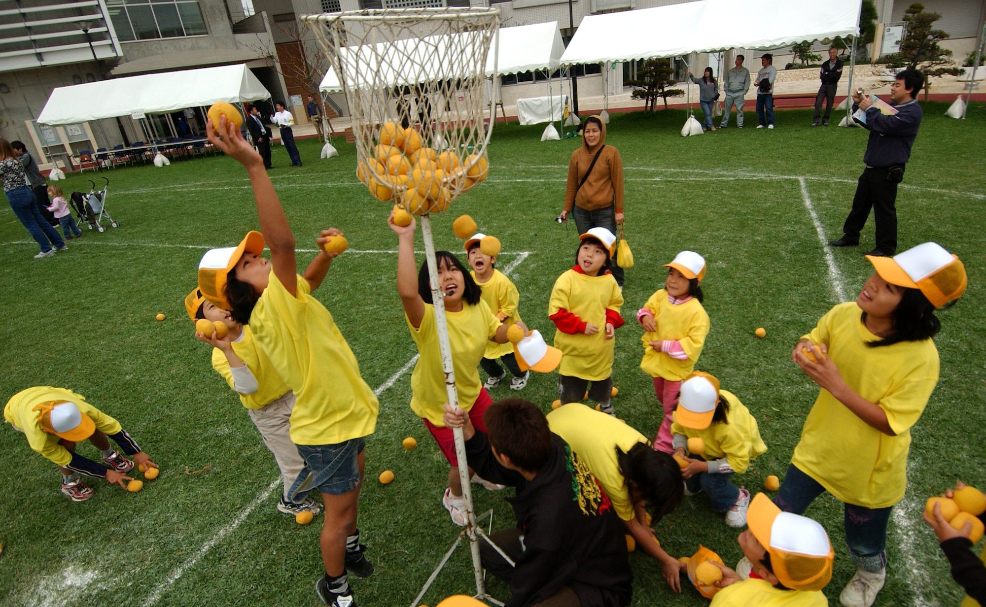 American and Okinawan children participate in tamaire where they throw balls in a basket and count in Japanese and English during the US-Japan Sports and Cultural Exchange at the Rotary Plaza Okinawa, Japan, March 14. (U.S. Air Force photo/Tech. Sgt. Rey Ramon)
                              