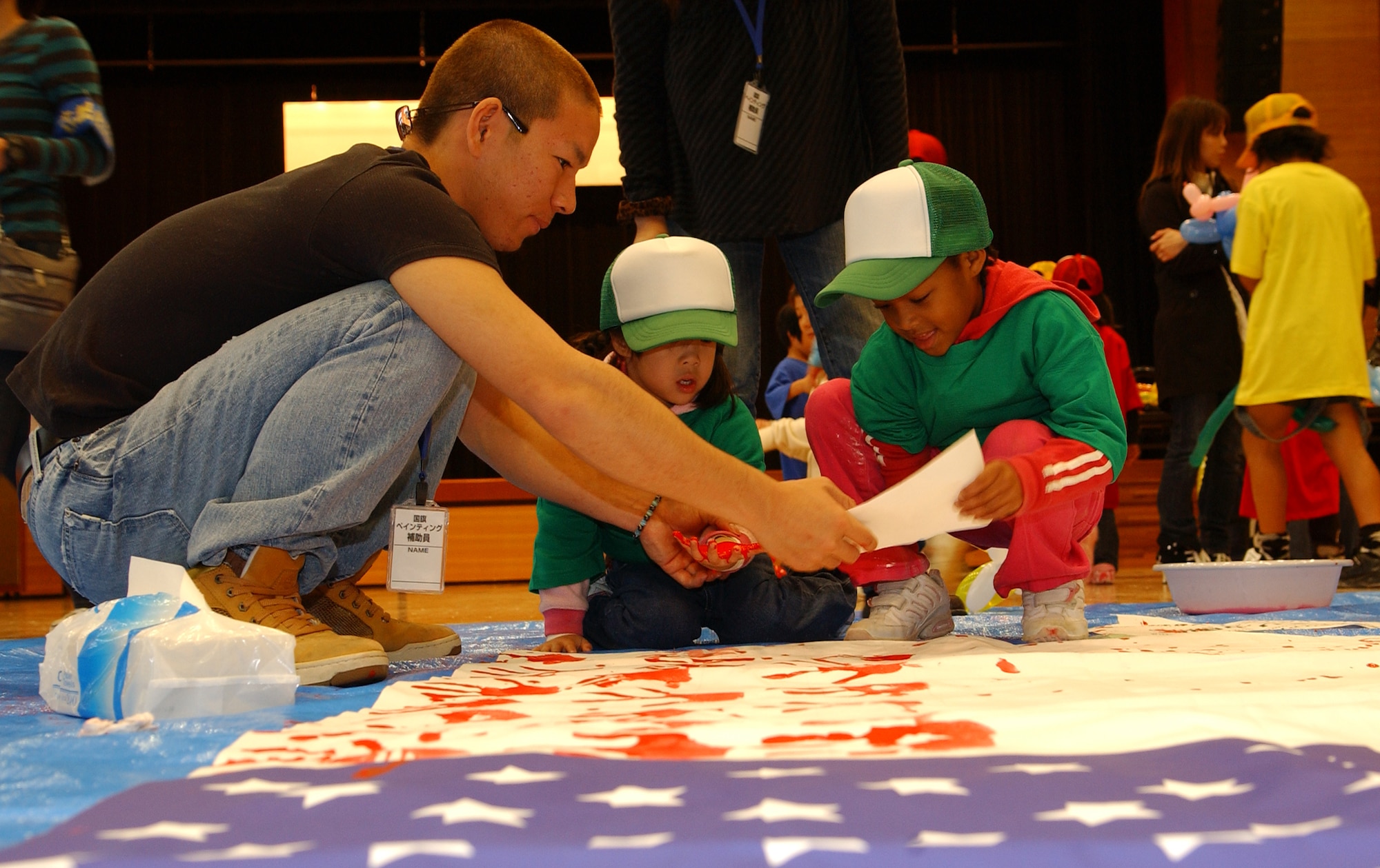 Children participate in an art exchange making hand prints on American and
Japanese flags during the U.S.-Japan Sports and Cultural Exchange at the
Rotary Plaza in Okinawa, Japan, March 14.  (U.S. Air Force photo/Tech. Sgt.
Rey Ramon)  