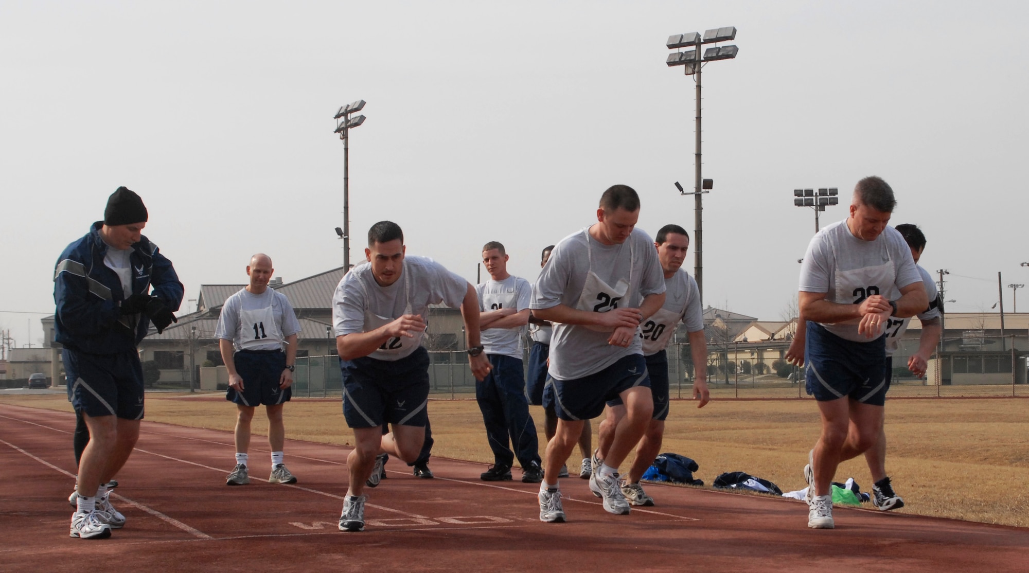 Colonel J.D. "Wolf" Harris, 8th Fighter Wing commander (far right), Col. Jon "Wolf 2" Huss, 8th Fighter Wing vice commander (far left), and other members of the Wolf Pack begin the 1.5 mile run portion of the physical fitness test at Kunsan Air Base, Republic of Korea, Mar. 12, 2009. The Health and Wellness Center will be the centralized location for all physical training testing. (U.S. Air Force photo by: Senior Airman Dana Hill)