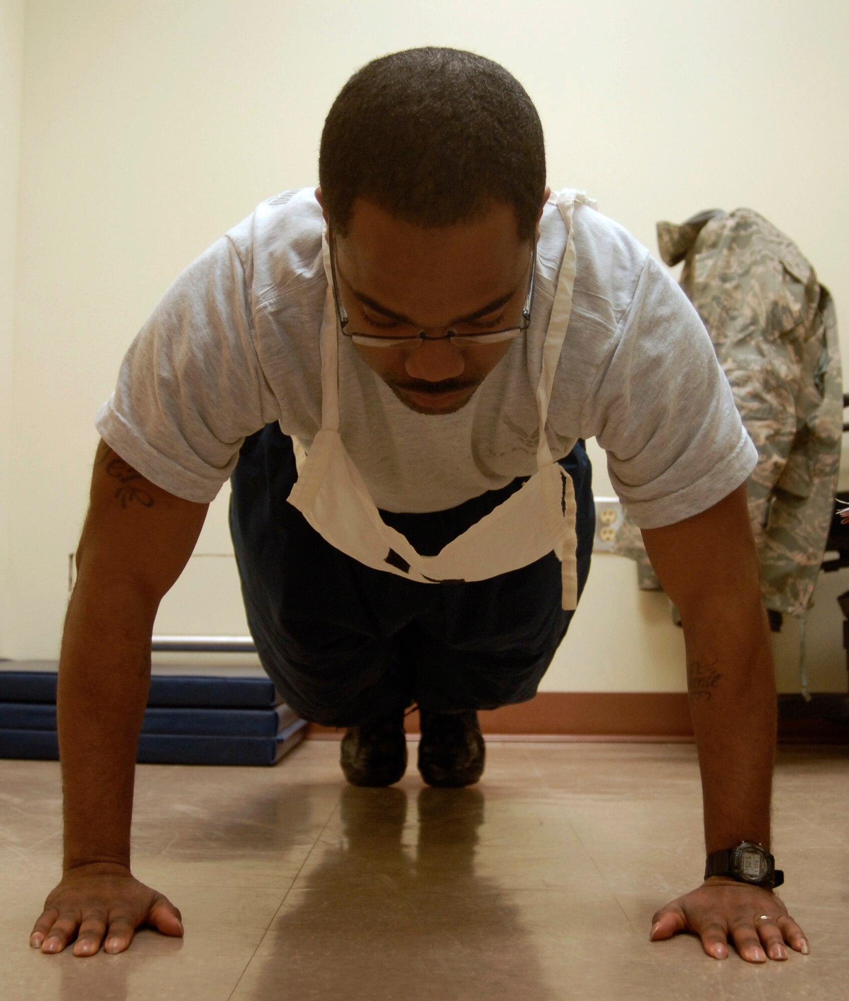 Senior Airman Demontinez Watts, 8th Logistics Readiness Squadron, begins the push up portion of his physical fitness test at Kunsan Air Base, Republic of Korea, Mar. 12, 2009. The base Health and Wellness Center is now the centralized location for all physical fitness testing. ( U.S. Air Force photo by: Senior Airman Dana Hill)