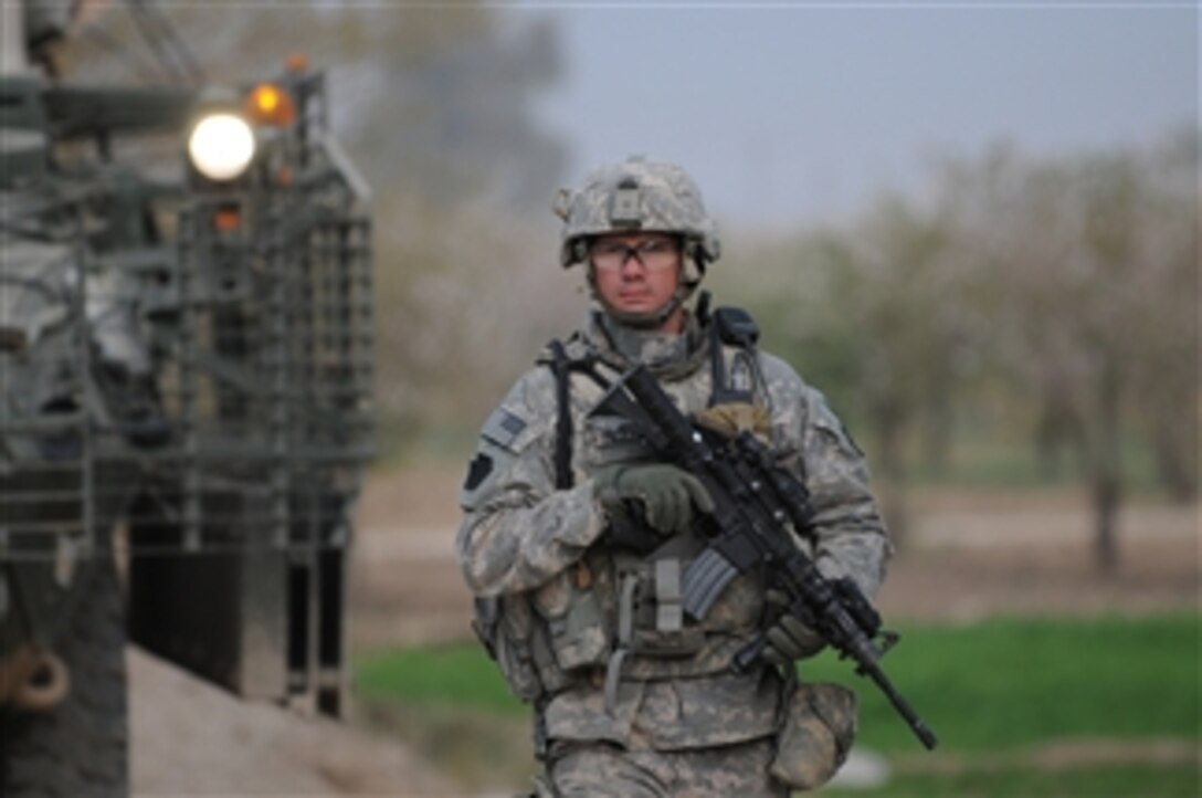 U.S. Army Sgt. Aaron Palczewski from Alfa Company, 1st Battalion, 111th Infantry Regiment, 56th Stryker Brigade Combat Team, 28th Infantry Division, Multi-National Division-Baghdad guides his Stryker combat vehicle while on a presence patrol to Nadeem Village, Iraq, on Mar. 4, 2009.  
