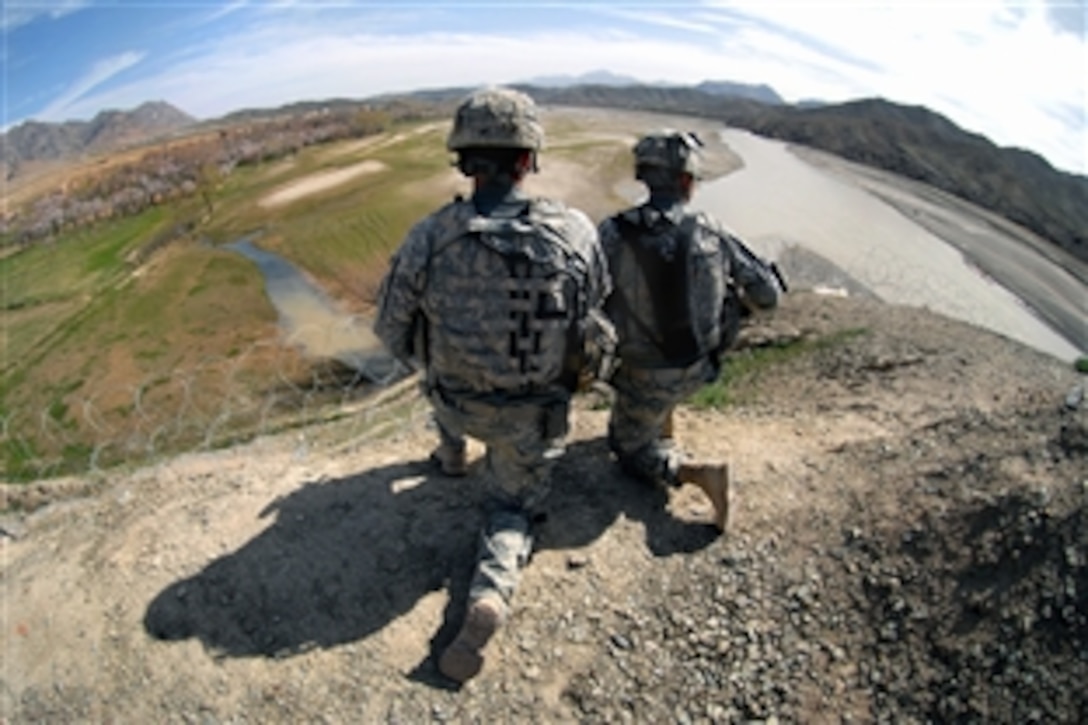 U.S. Army Spcs. Curtis Widel, left, and Juan Castro, look at the Arghandab River near Forward Operating Base Lane in Zabul province, Afghanistan, March 11, 2009. Widel and Castro are assigned to Company B, 1st Battalion, 4th Infantry Regiment.