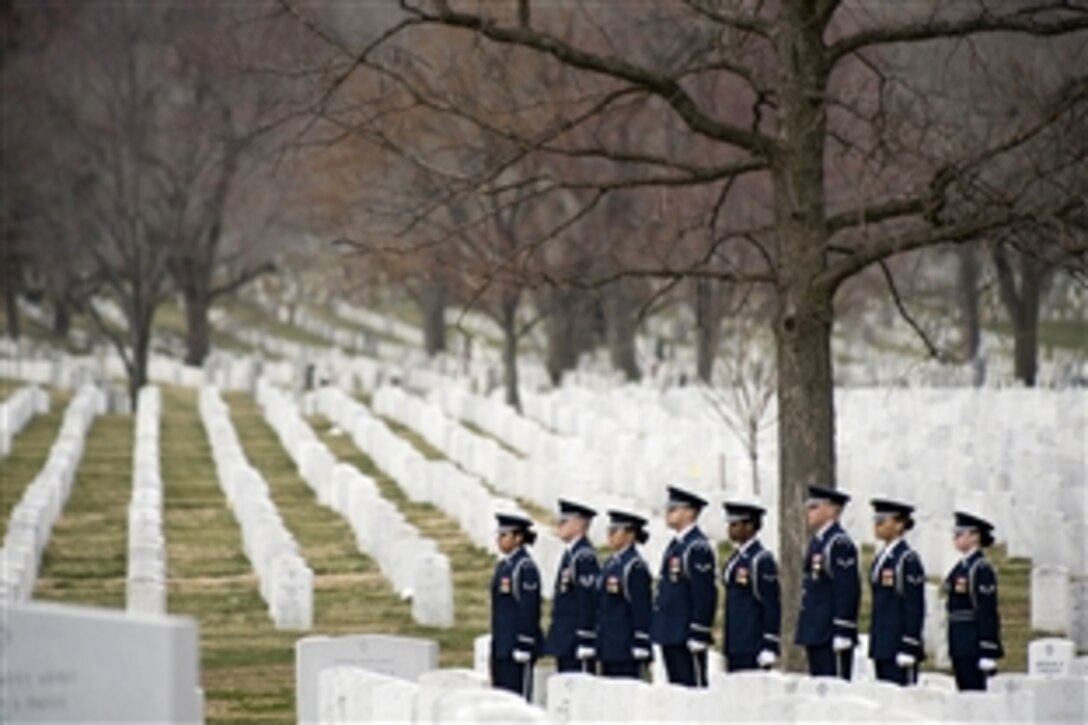 A U.S. Air Force Honor Guard prepares to fire three rifle volleys at a funeral at Arlington National Cemetery,  March 11, 2009.